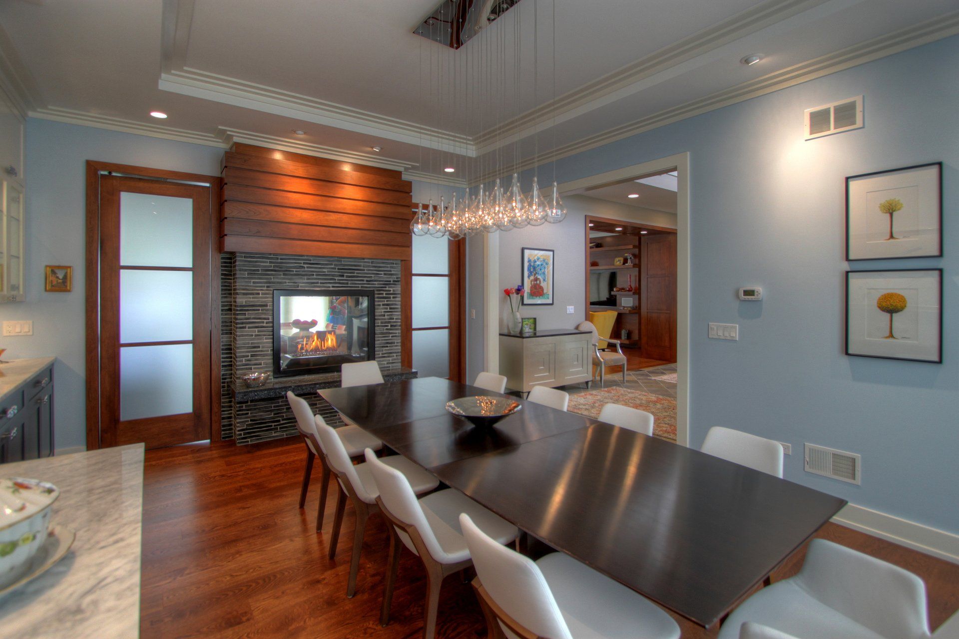 A dining room with a table and chairs and a fireplace