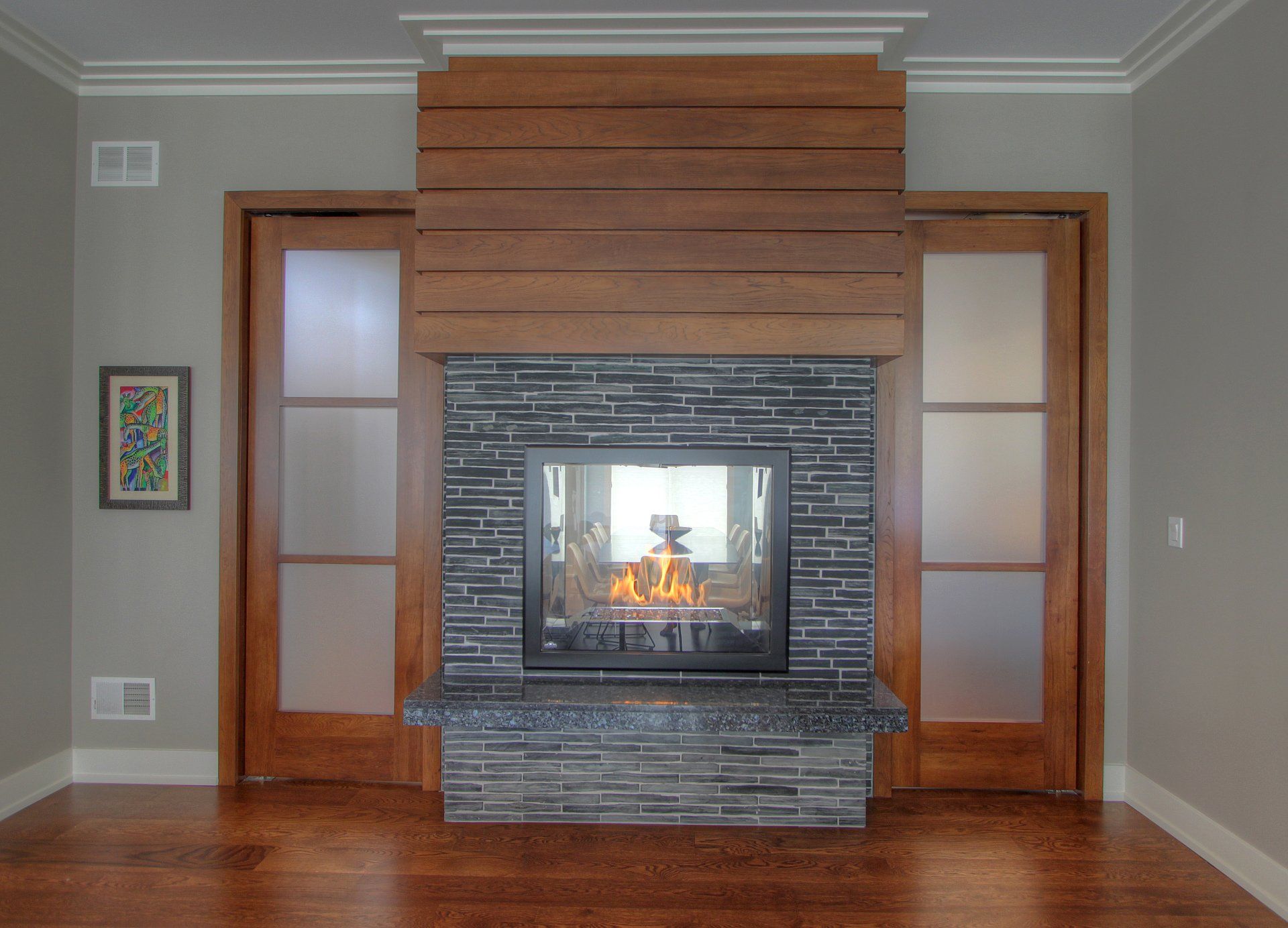 A living room with a fireplace and sliding glass doors