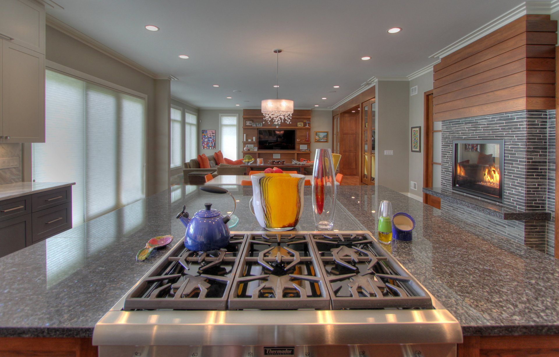 A kitchen with a stove top oven and a fireplace