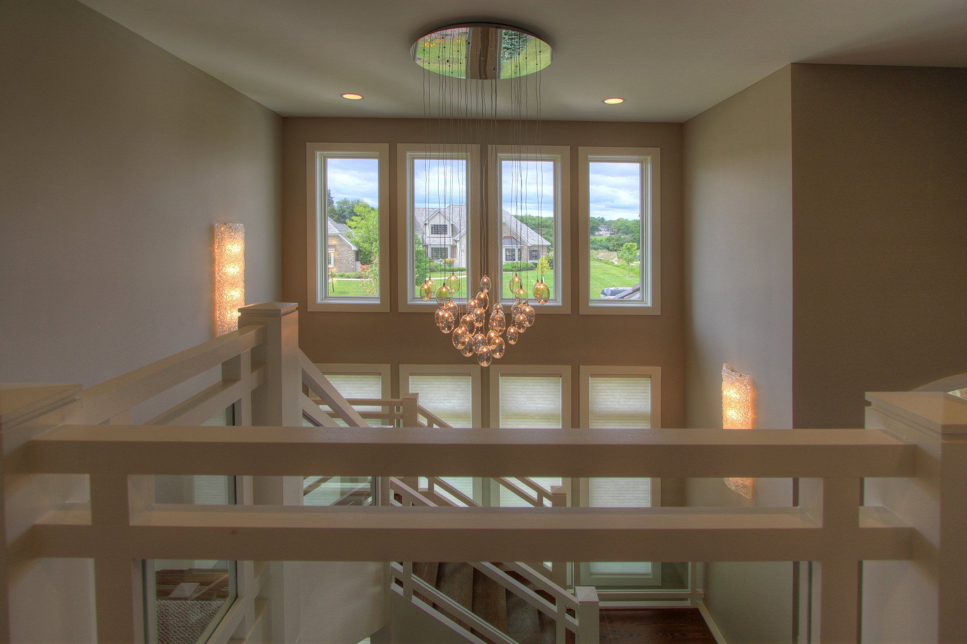 A staircase with a chandelier hanging from the ceiling