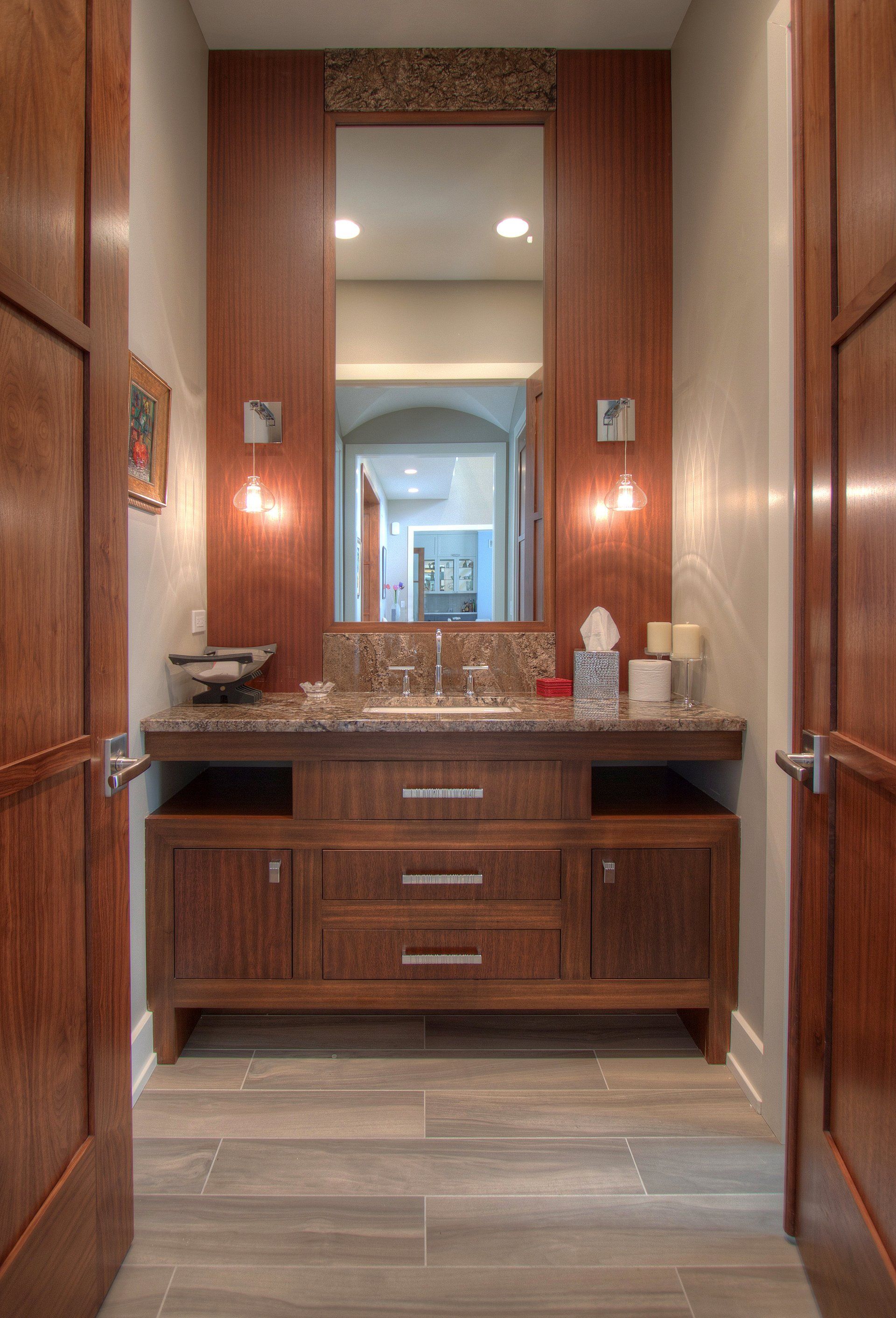 A bathroom with two sinks and a large mirror.