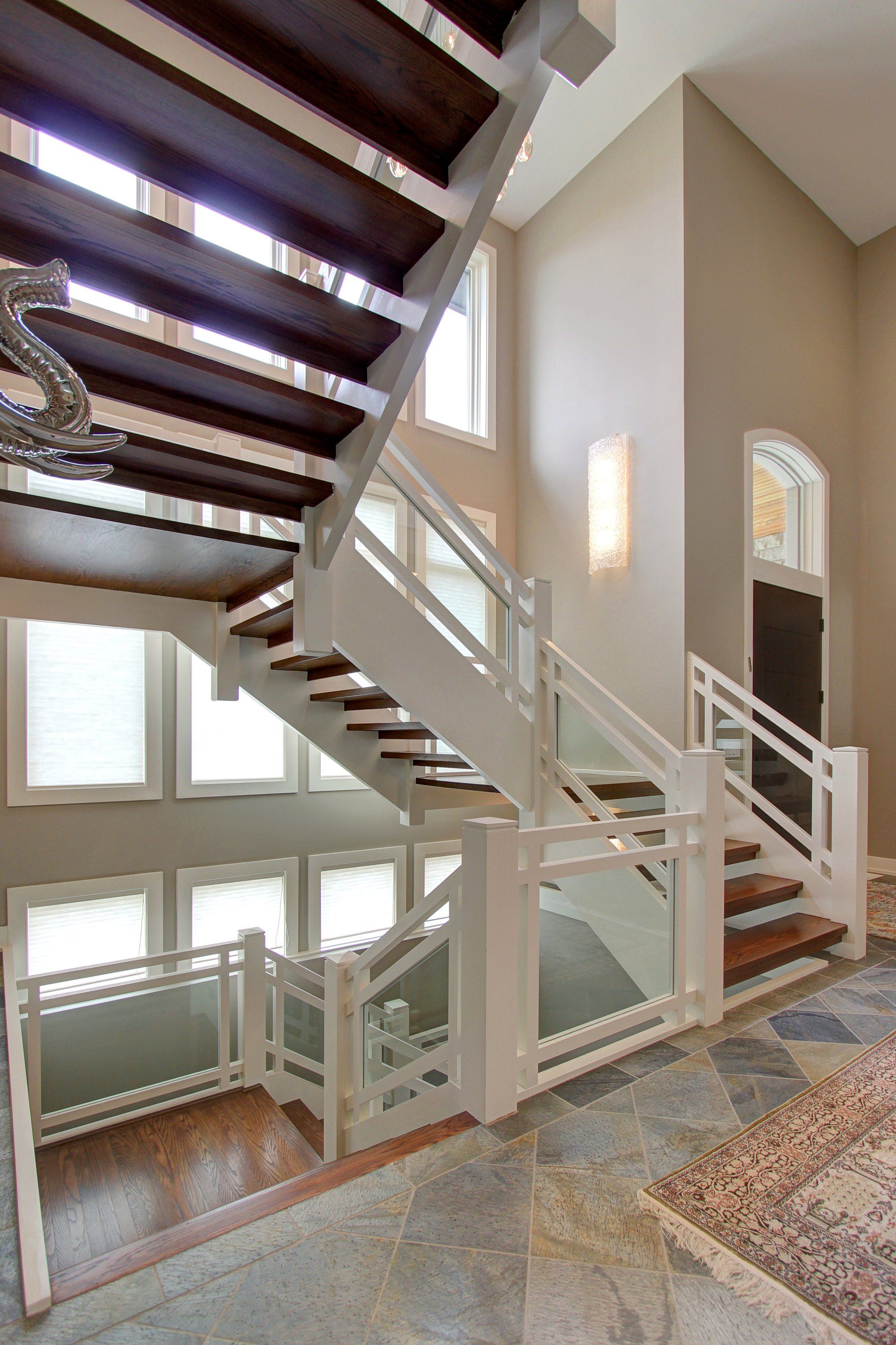 A staircase with wooden steps and a white railing