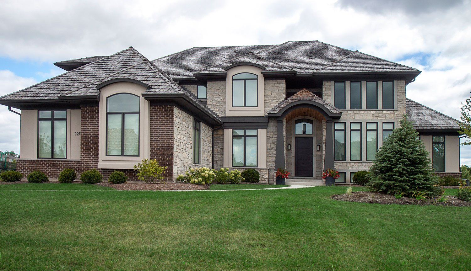 A large house with a lot of windows and a slate roof