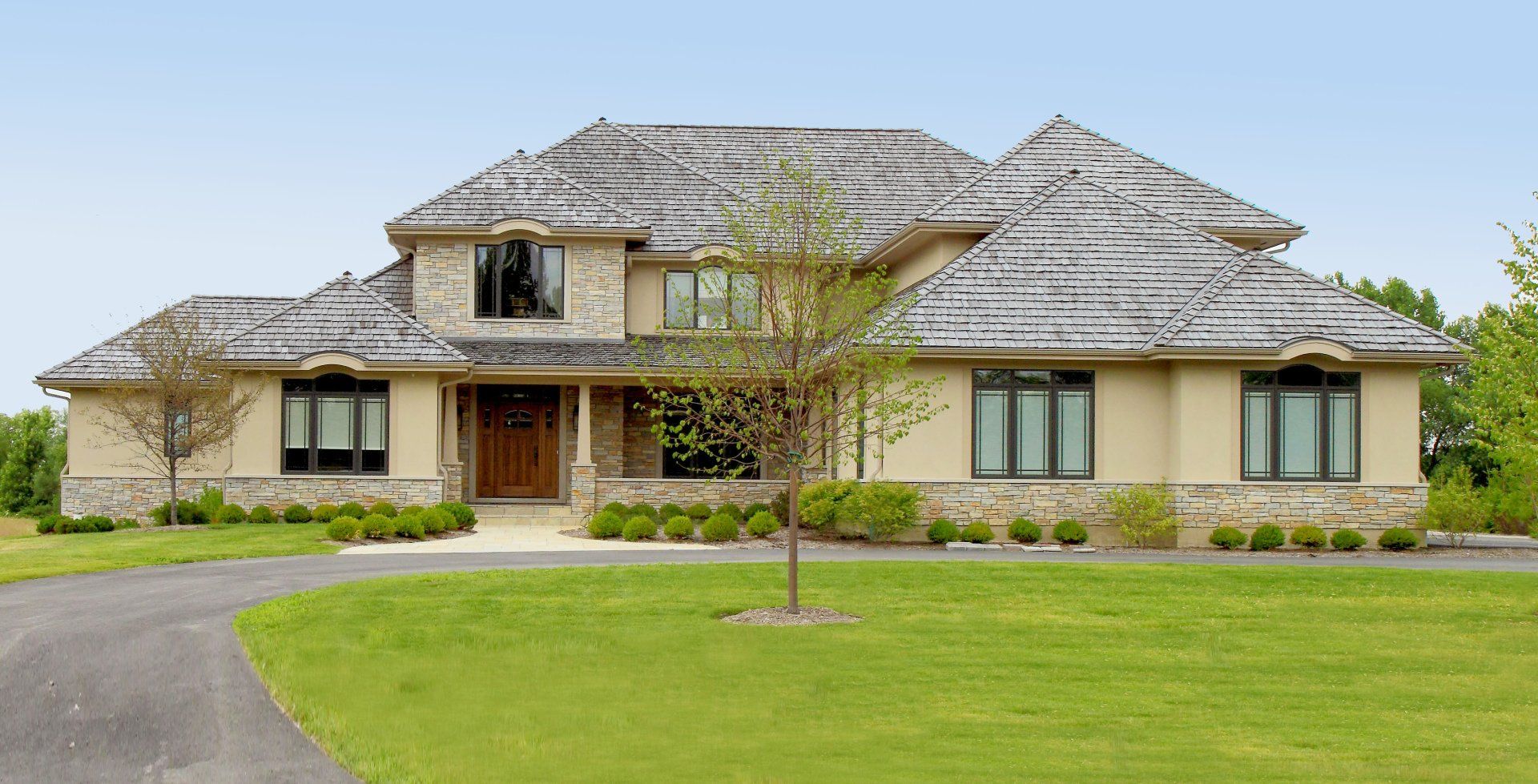 A large house with a tree in front of it