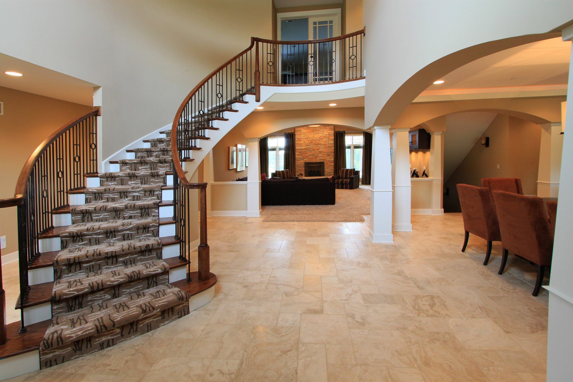A large house with a curved staircase leading up to the second floor