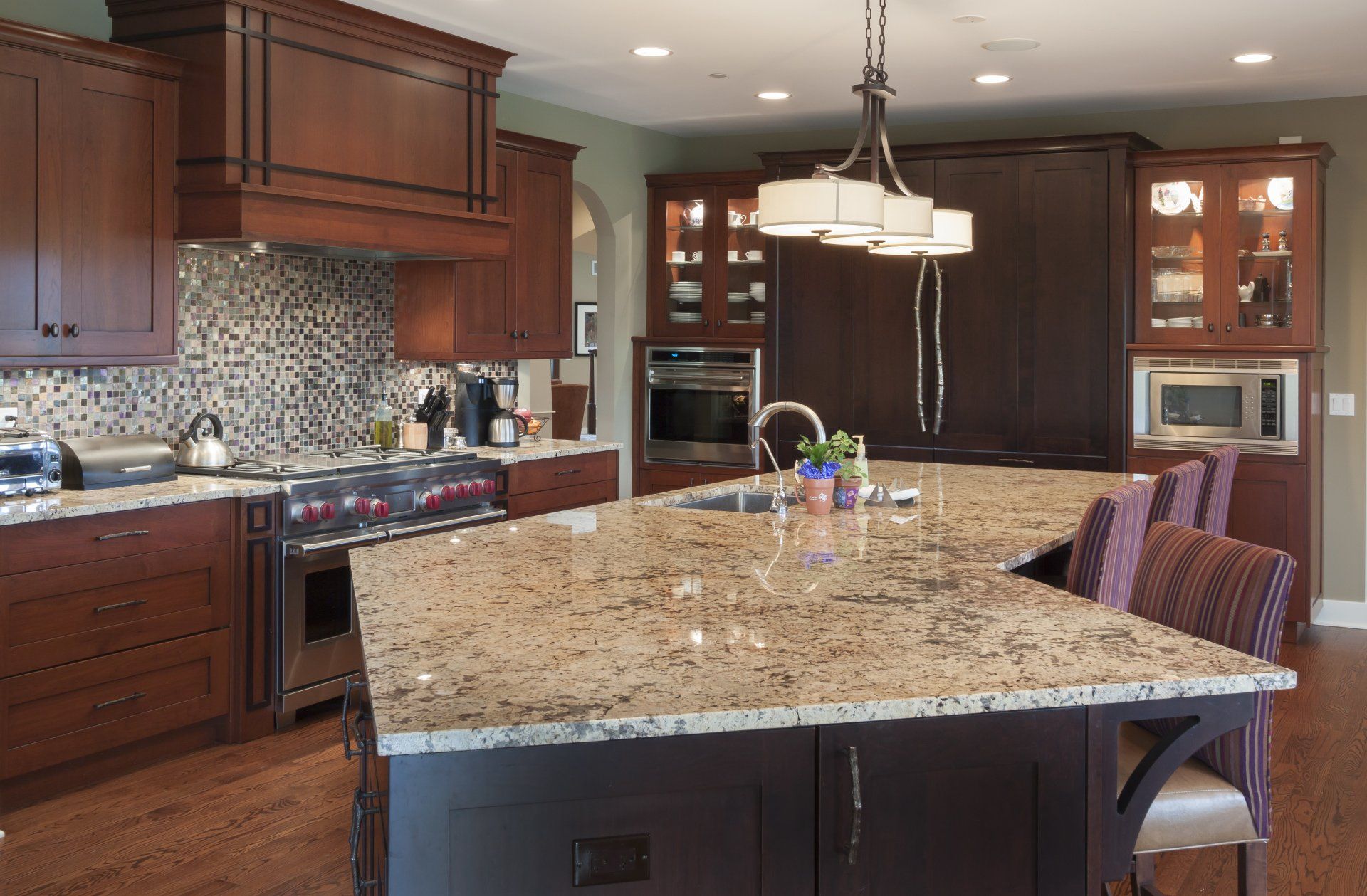 A kitchen with granite counter tops and wooden cabinets