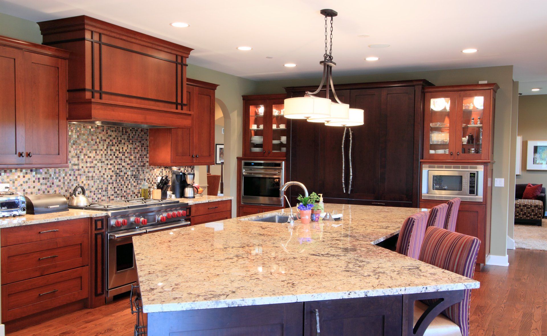 A kitchen with granite counter tops and wooden cabinets
