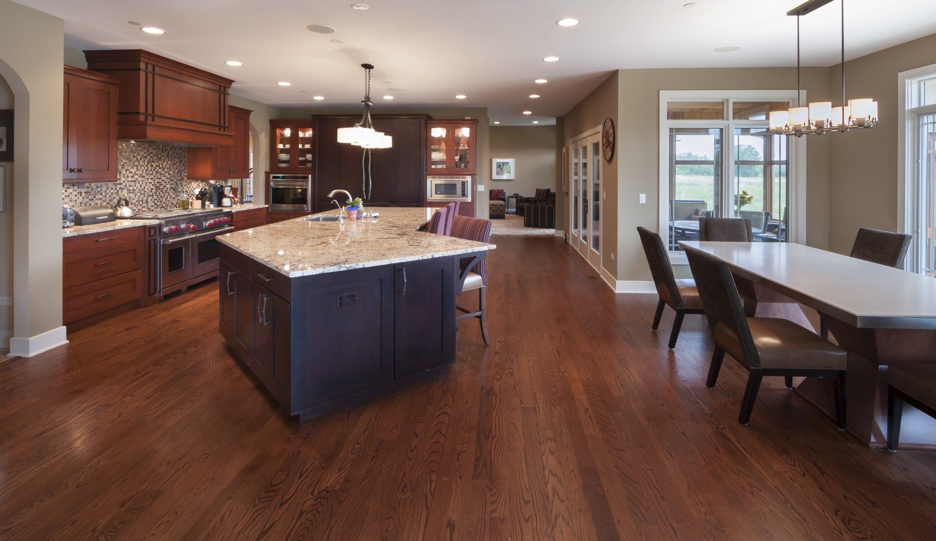 A kitchen and dining room in a house with hardwood floors.