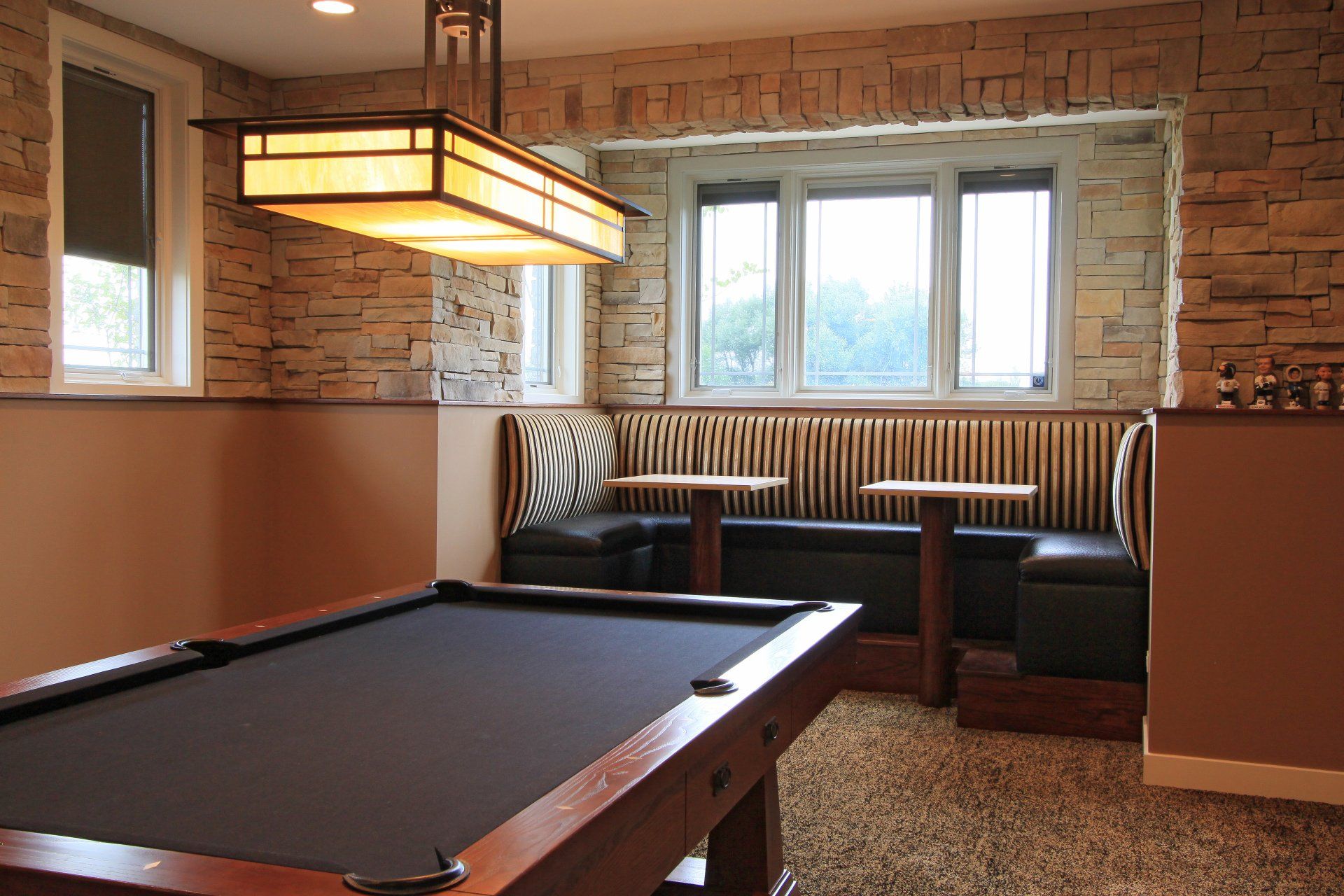 A pool table in a room with a brick wall