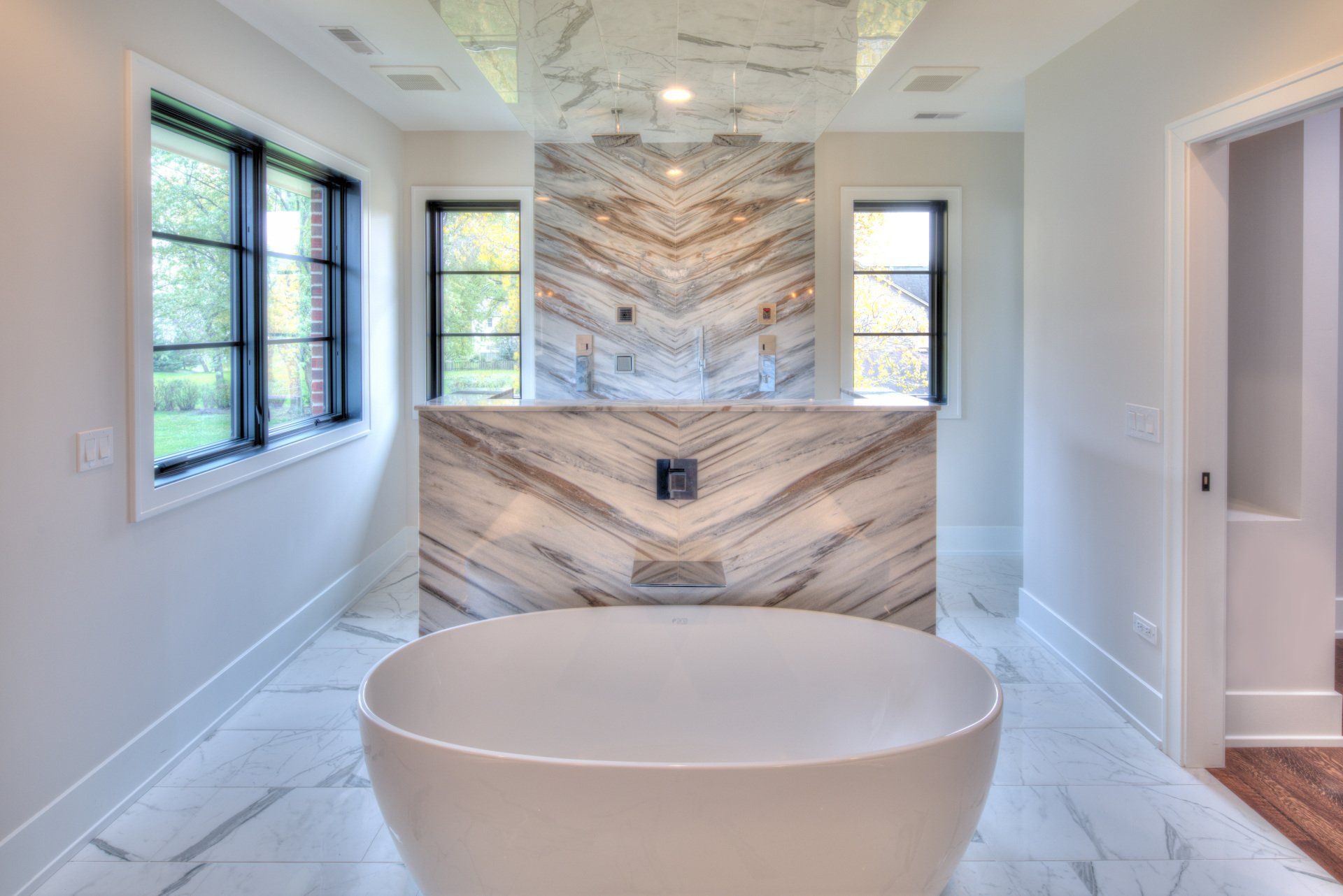 There is a bathtub in the middle of the bathroom.