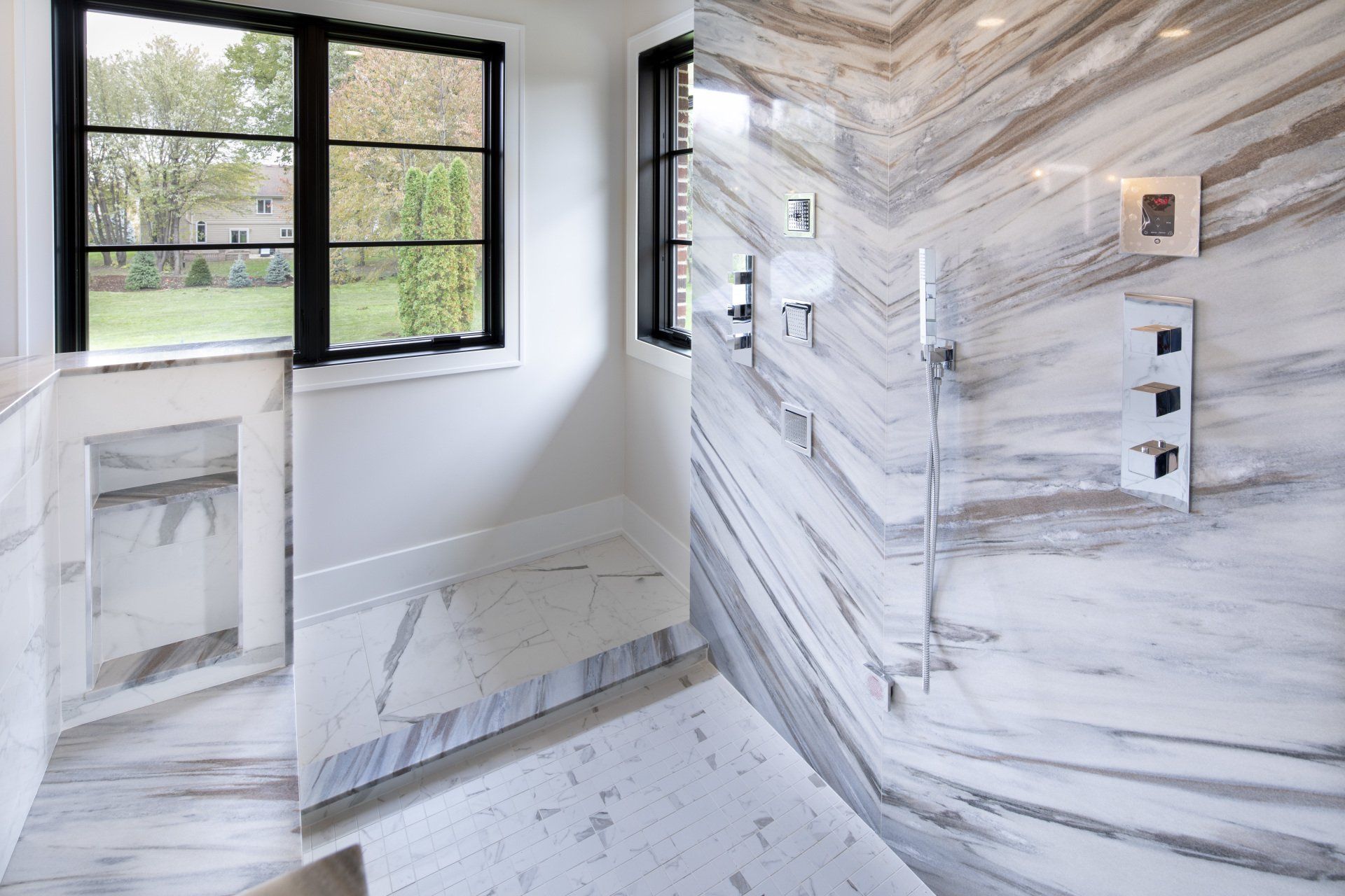 A bathroom with a marble shower and a window