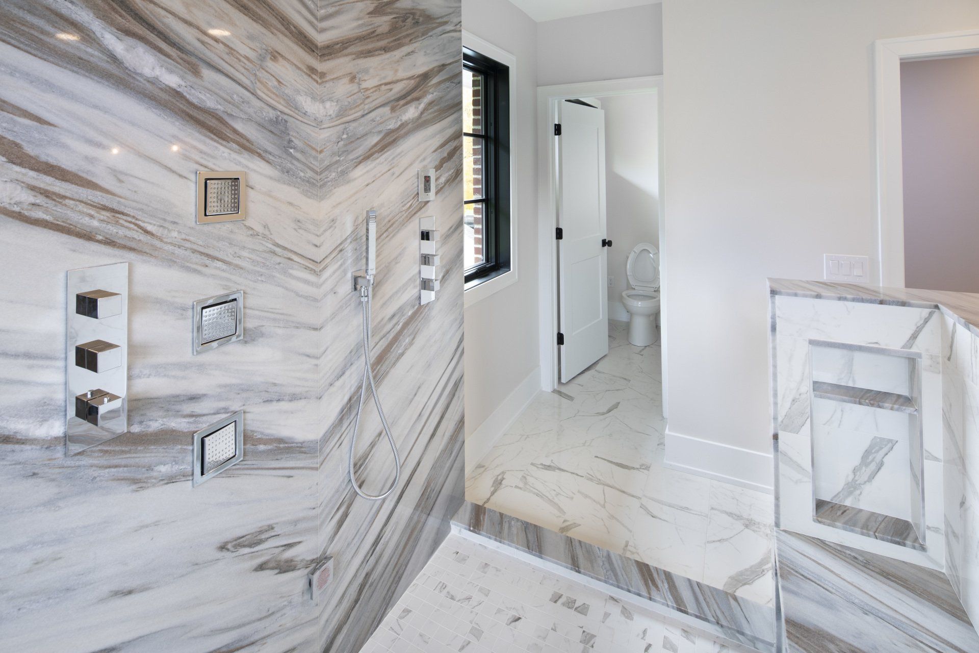 A bathroom with a walk in shower and a toilet.