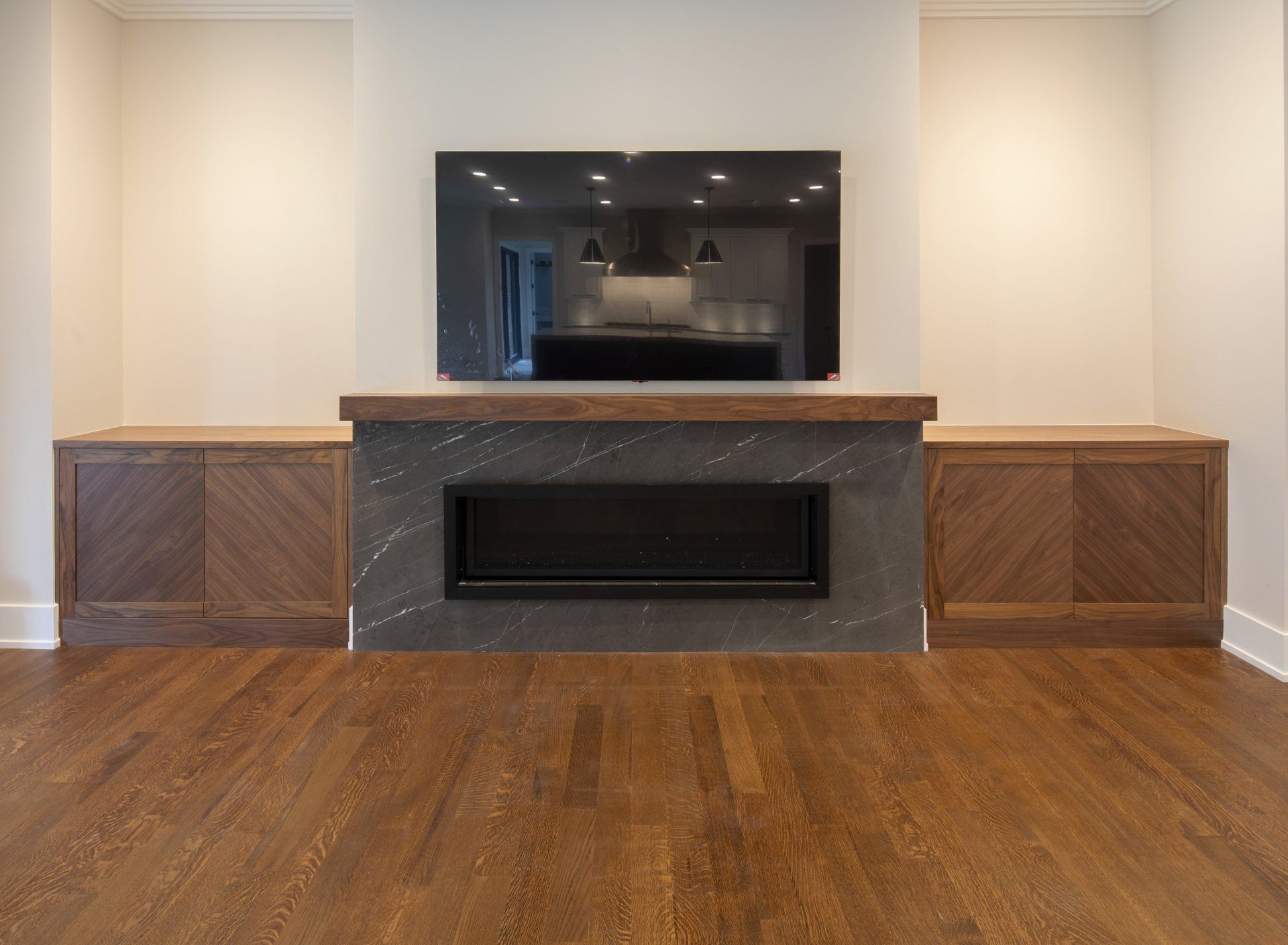 A living room with a fireplace and a flat screen tv on the wall.