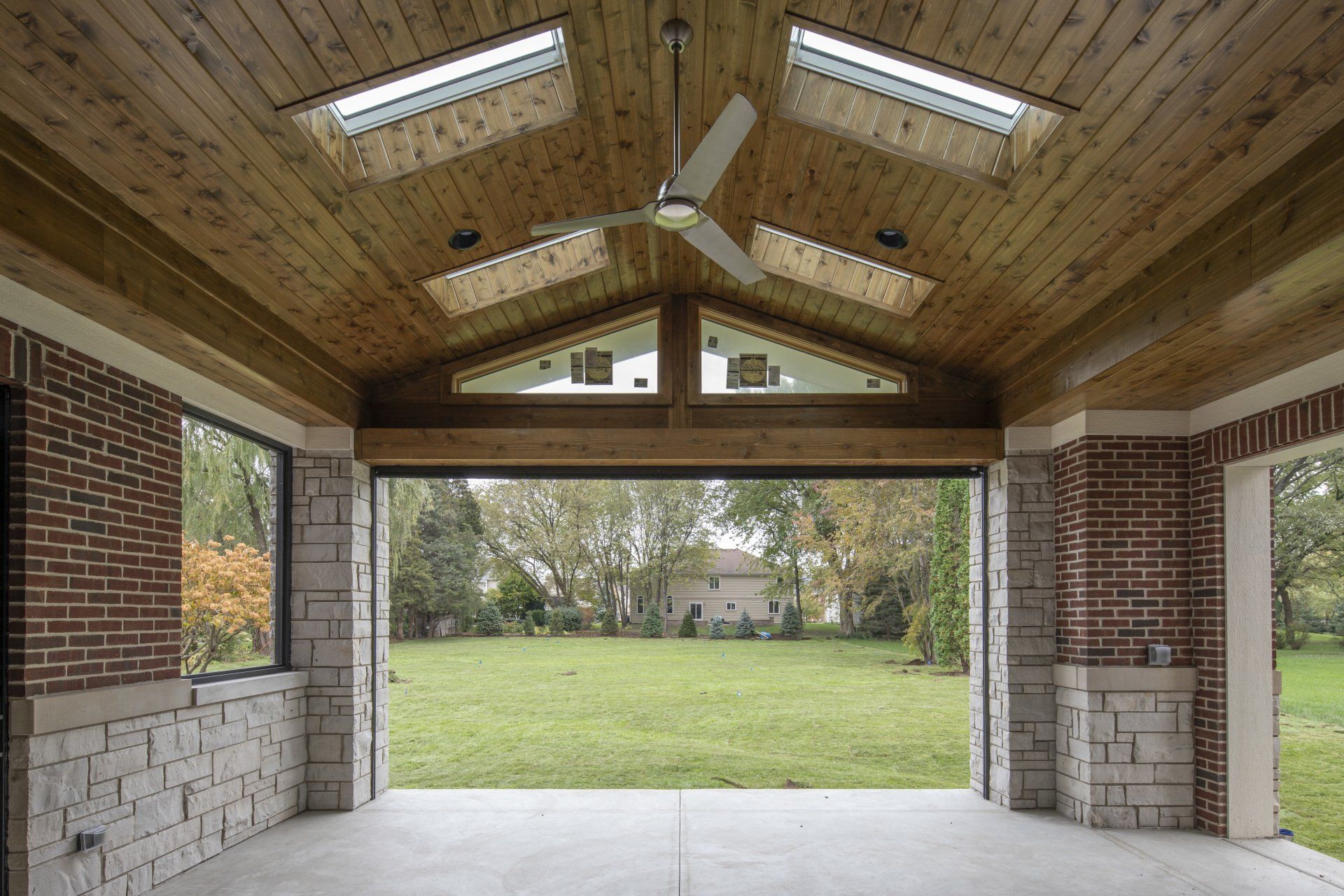 The inside of a building with a ceiling fan and skylights