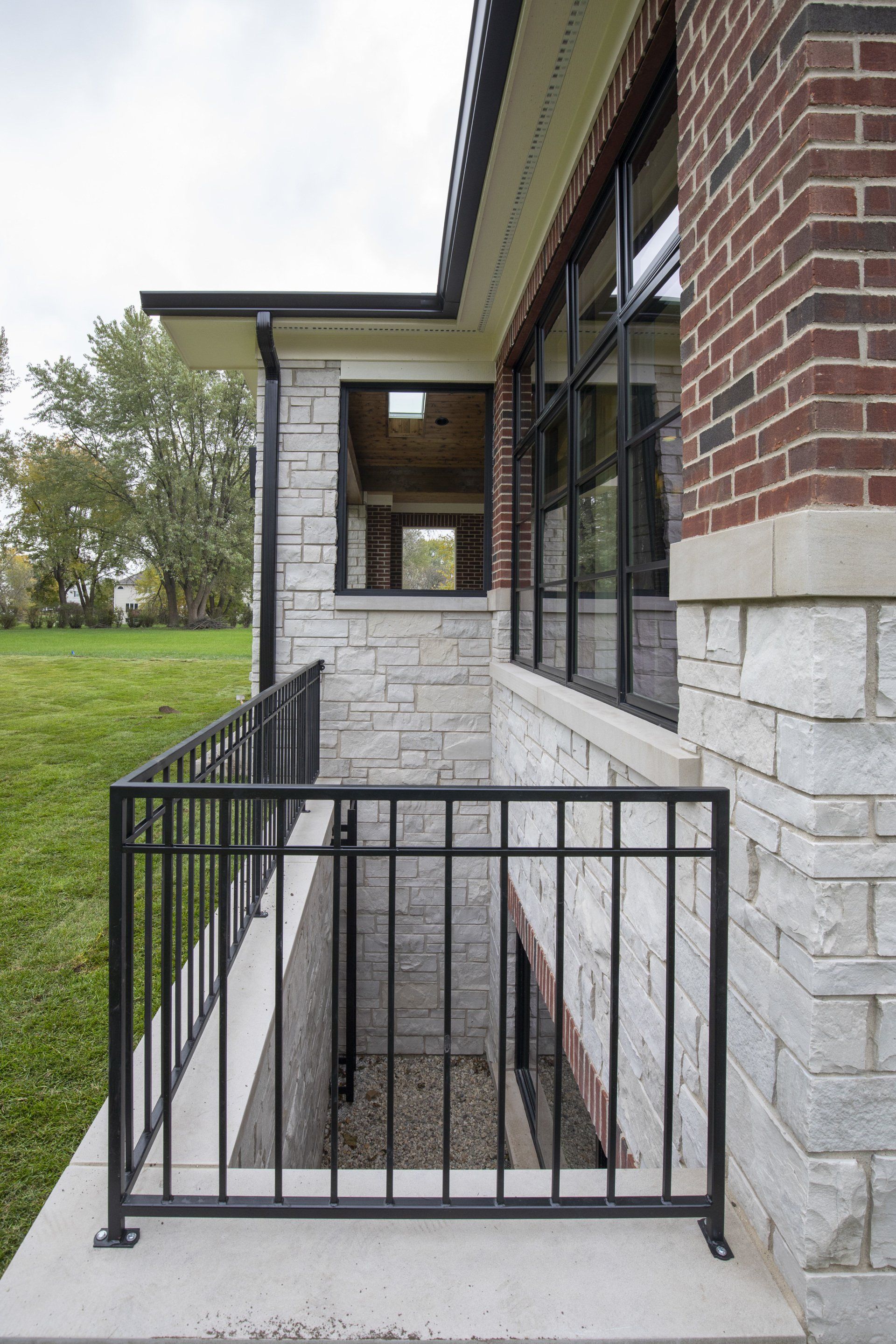 A brick building with a balcony and a window.
