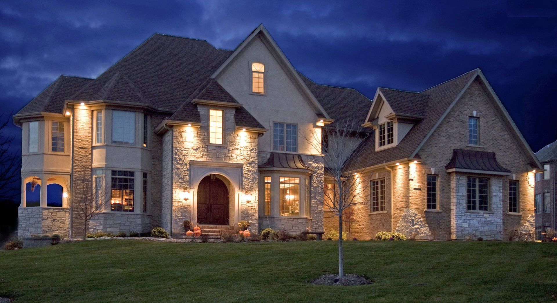 A large house that is lit up at night