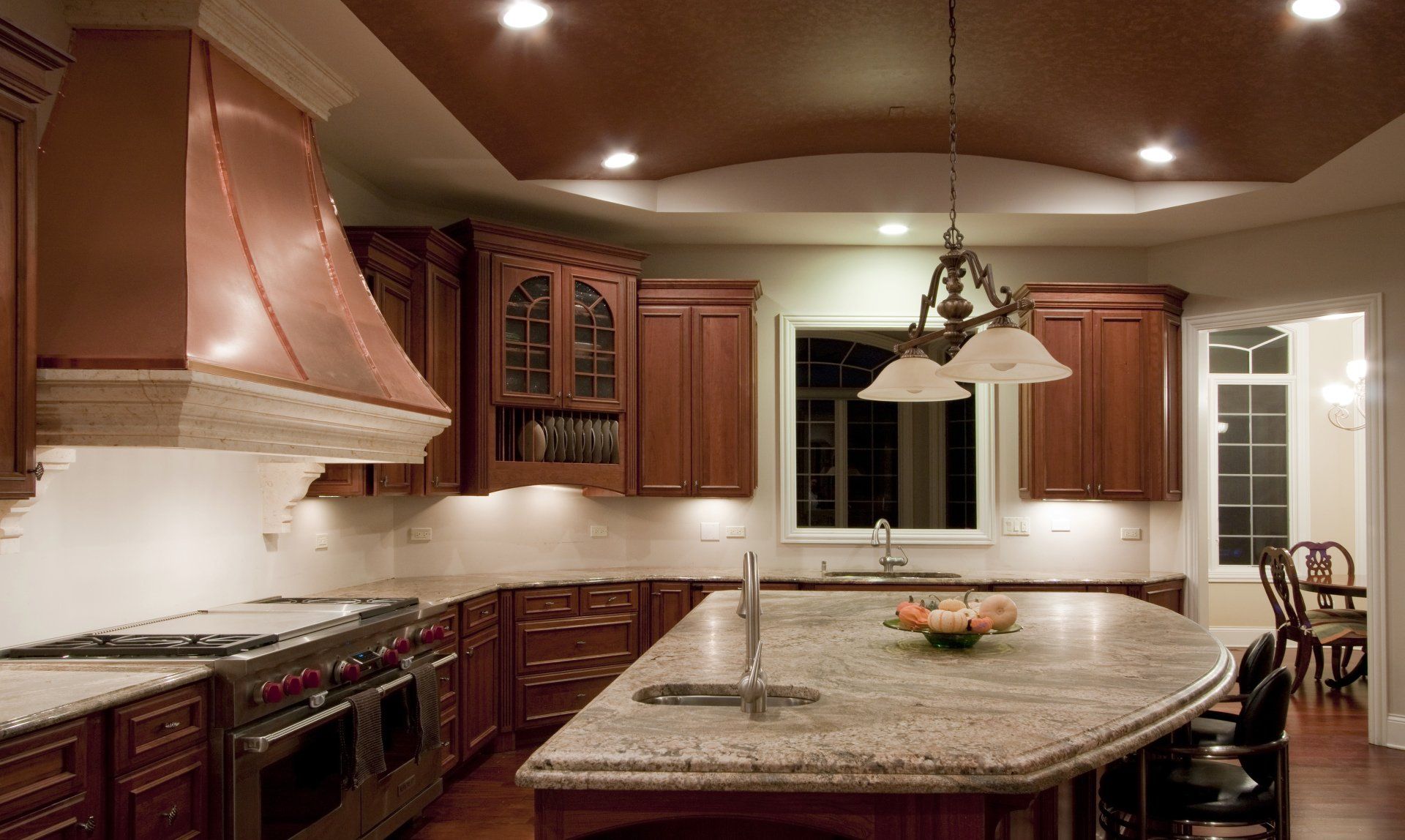 A kitchen with wooden cabinets and granite counter tops