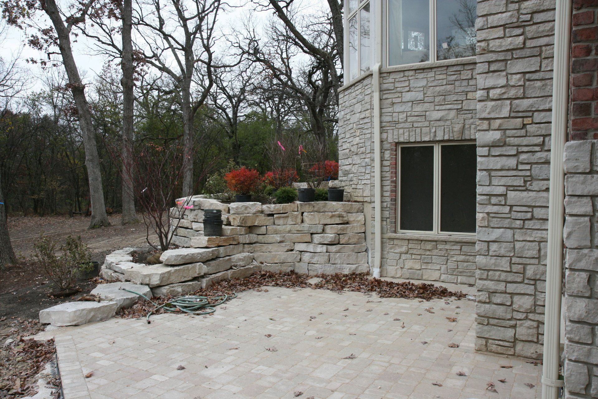 A brick building with a window and a patio in front of it