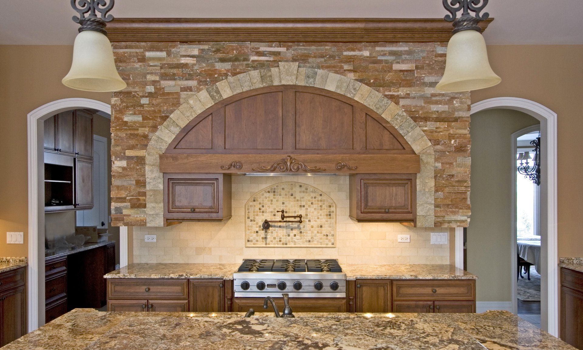 A kitchen with a stove top oven and granite counter tops