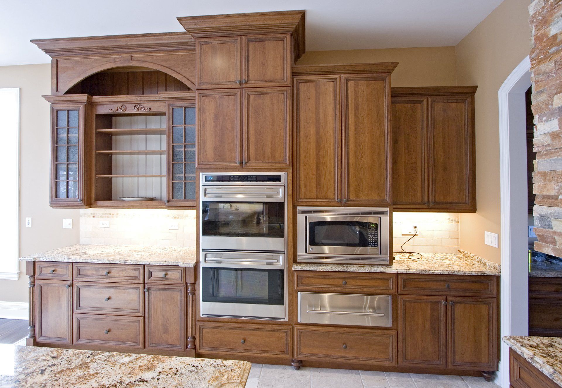 A kitchen with wooden cabinets and stainless steel appliances