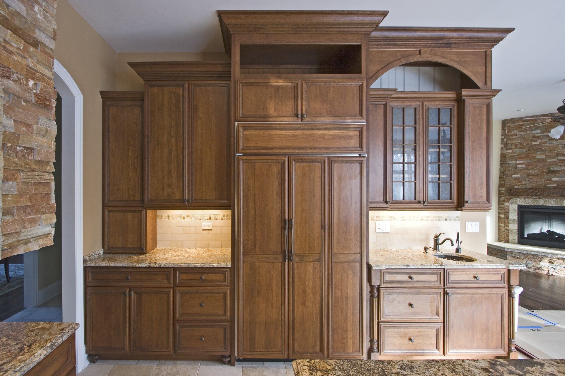 A kitchen with wooden cabinets and granite counter tops