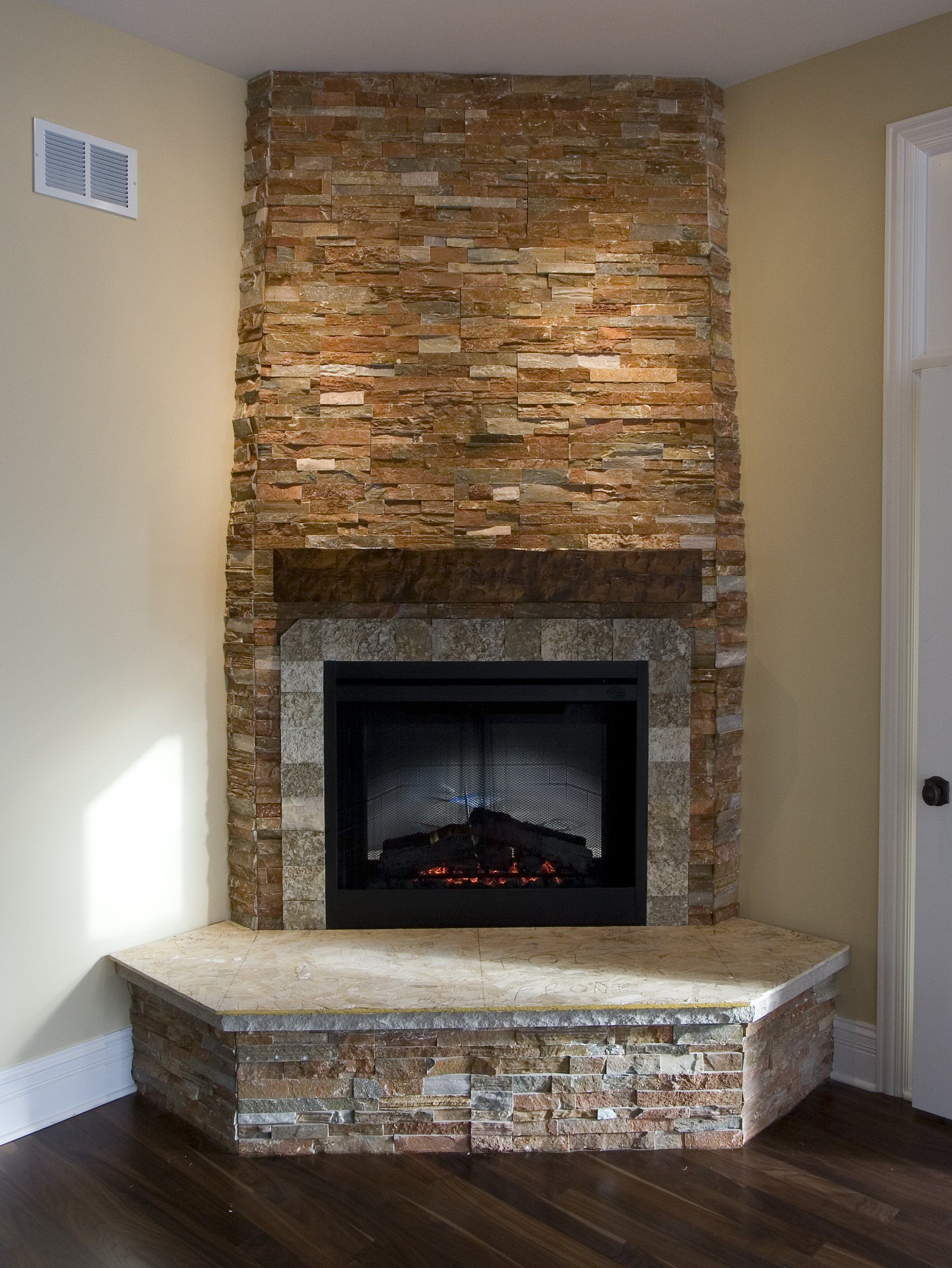 There is a fireplace in the corner of the room.