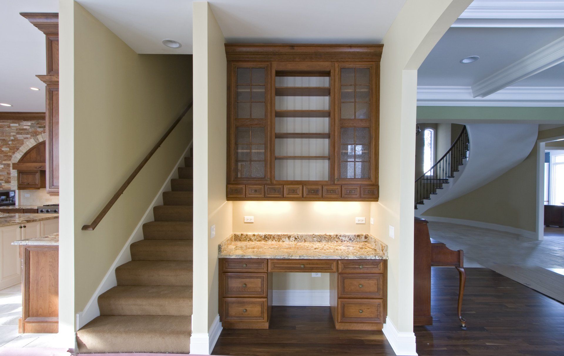A home with stairs and a desk in the middle