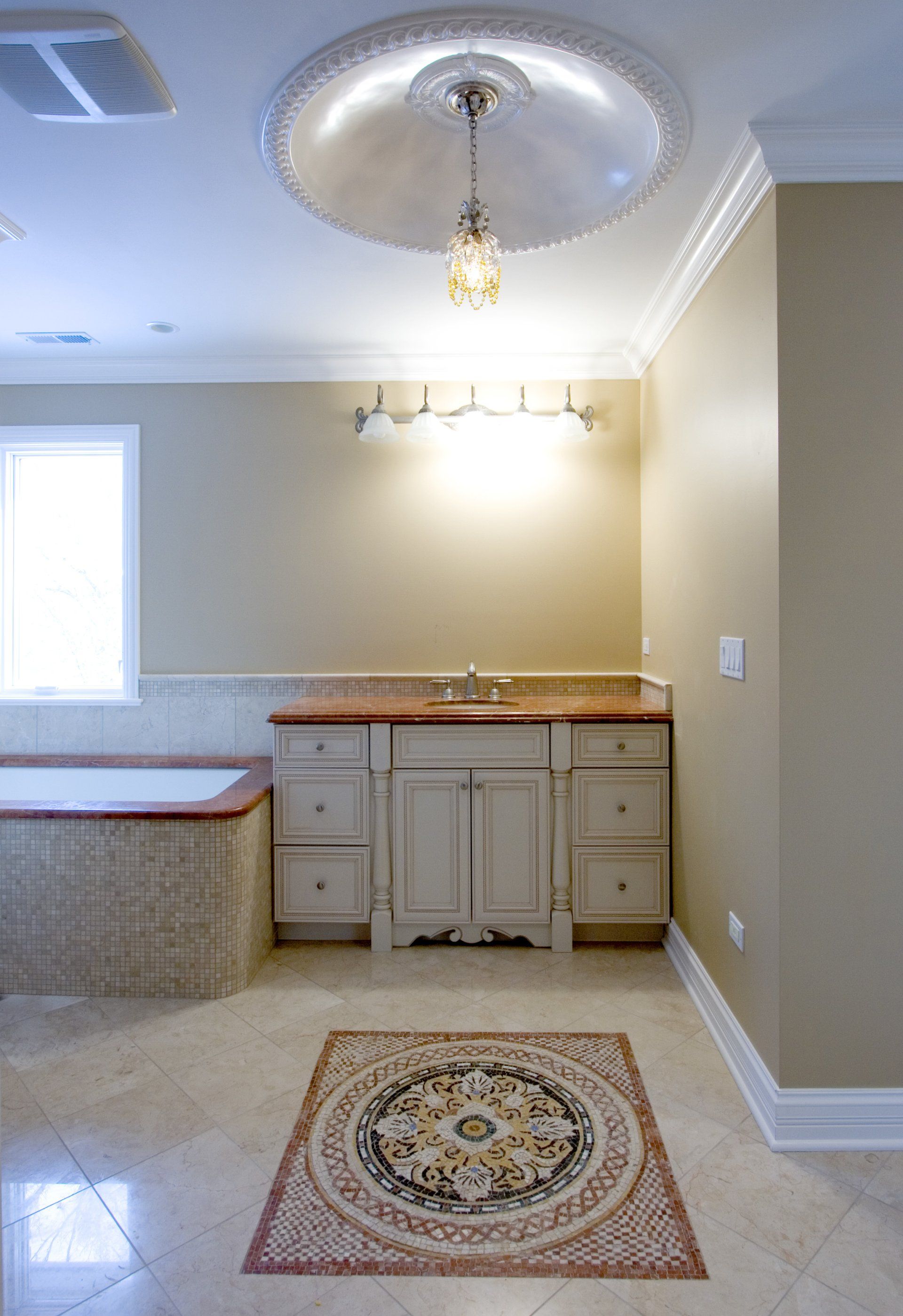 A bathroom with a sink and a bathtub and a rug on the floor.
