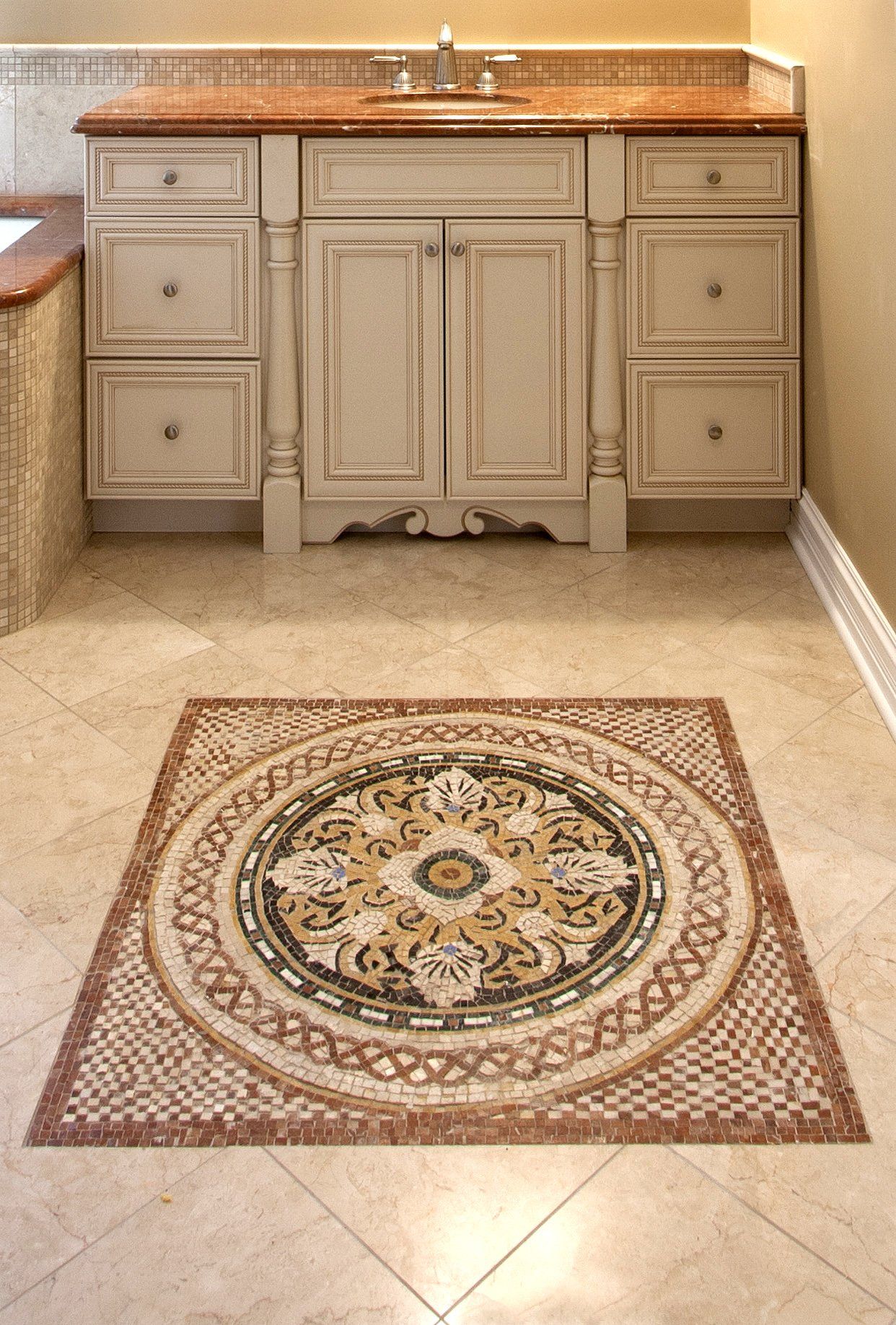 A bathroom with a sink and a mosaic floor
