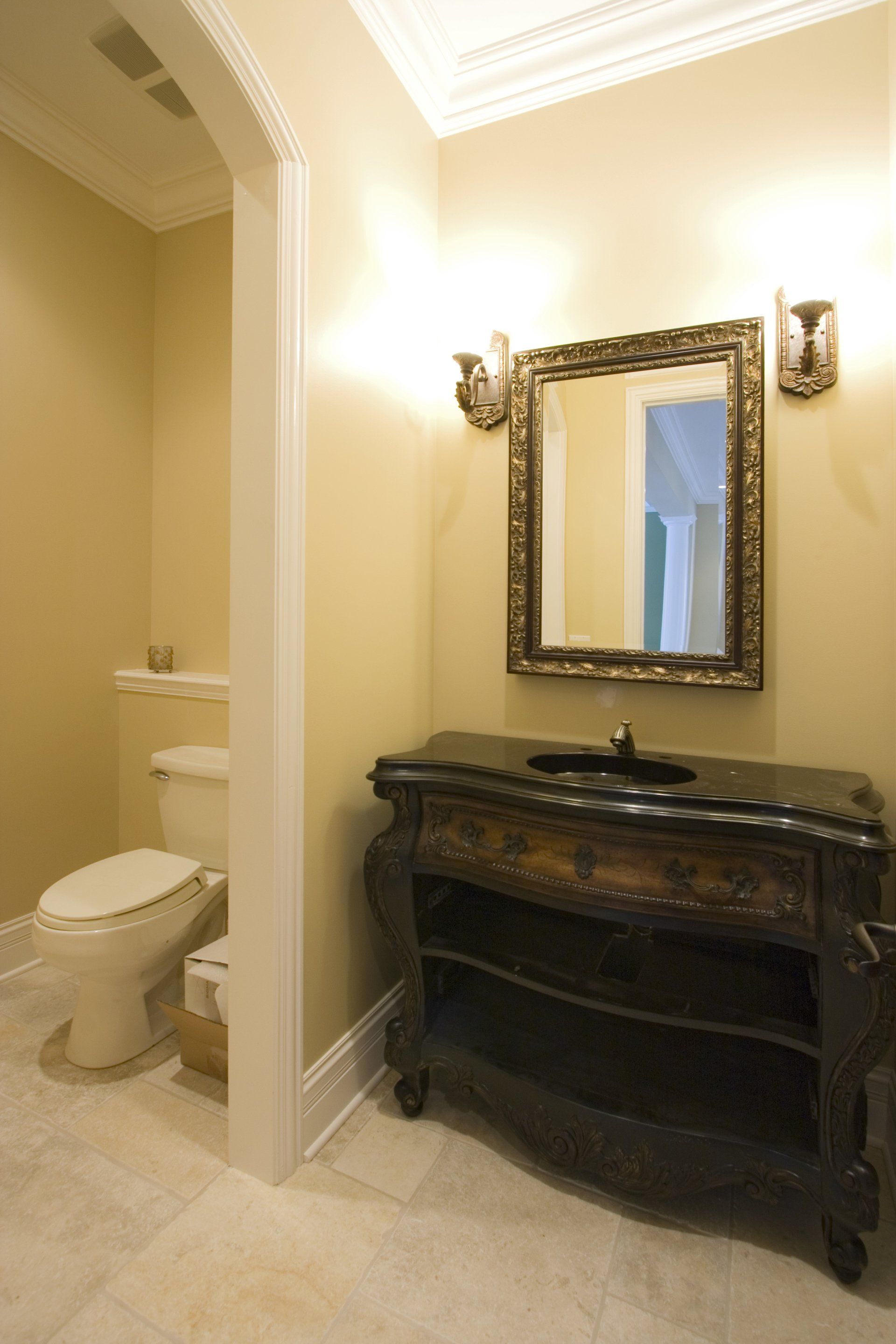 A bathroom with a toilet a sink and a mirror