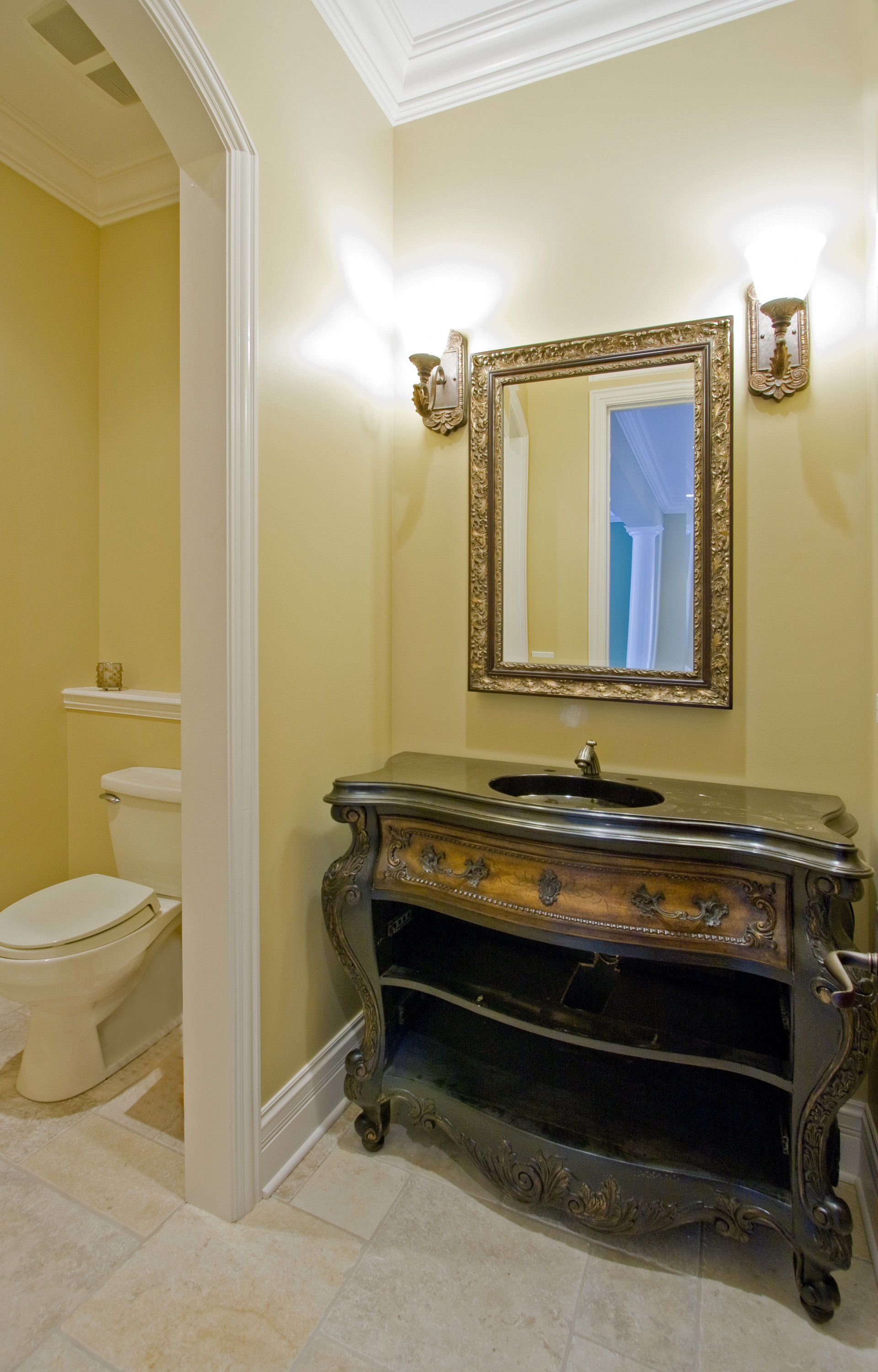 A bathroom with a toilet a sink and a mirror