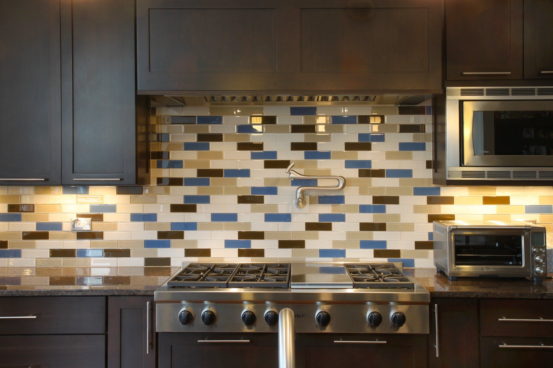 A kitchen with a stove top oven and a microwave