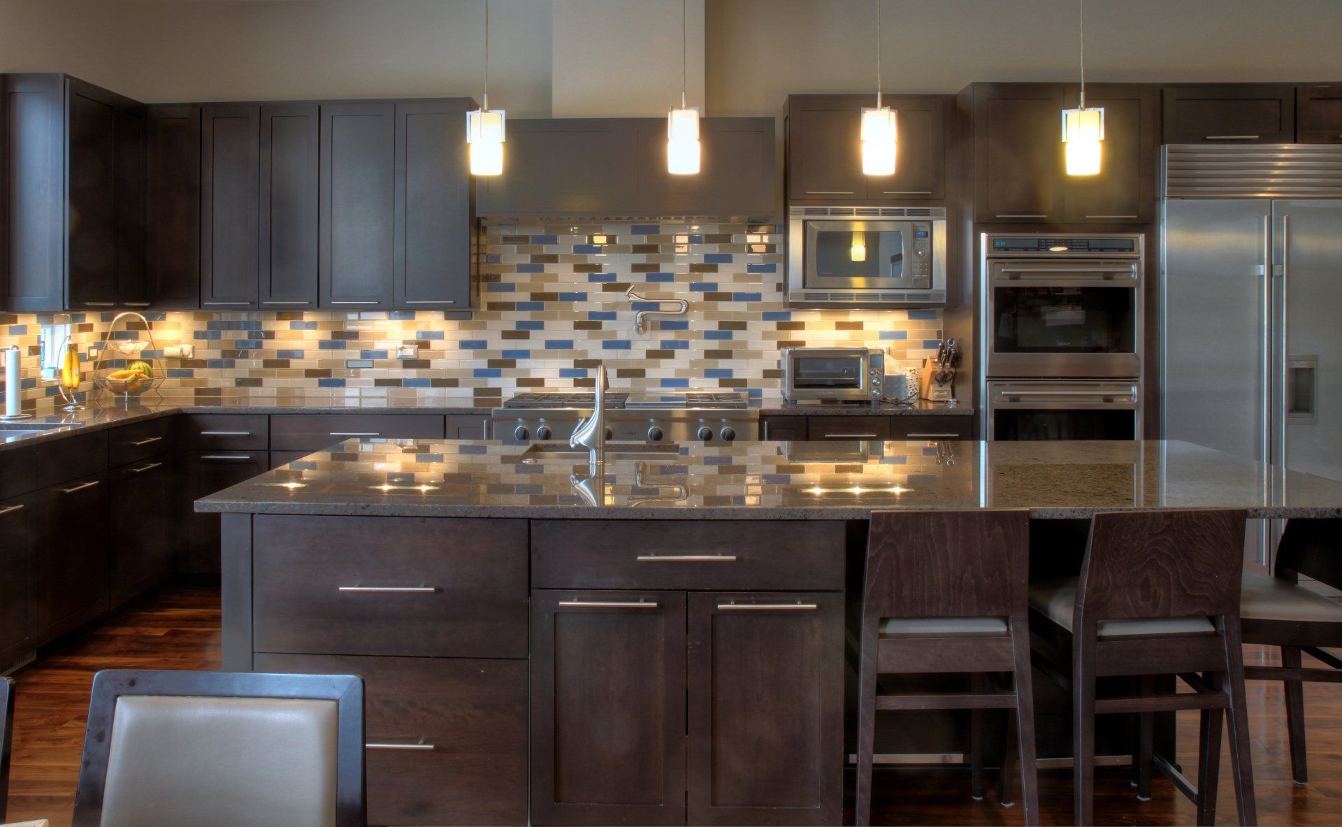 A kitchen with stainless steel appliances and a large island