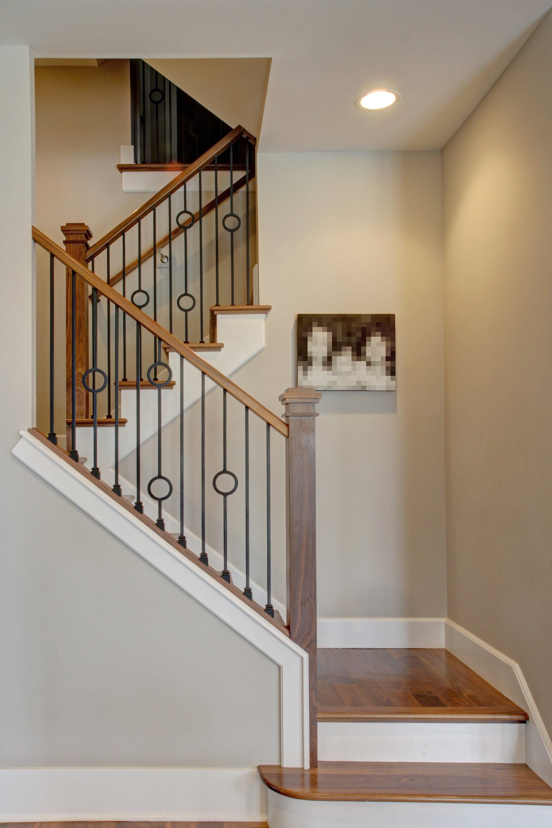 A staircase with a wrought iron railing in a house
