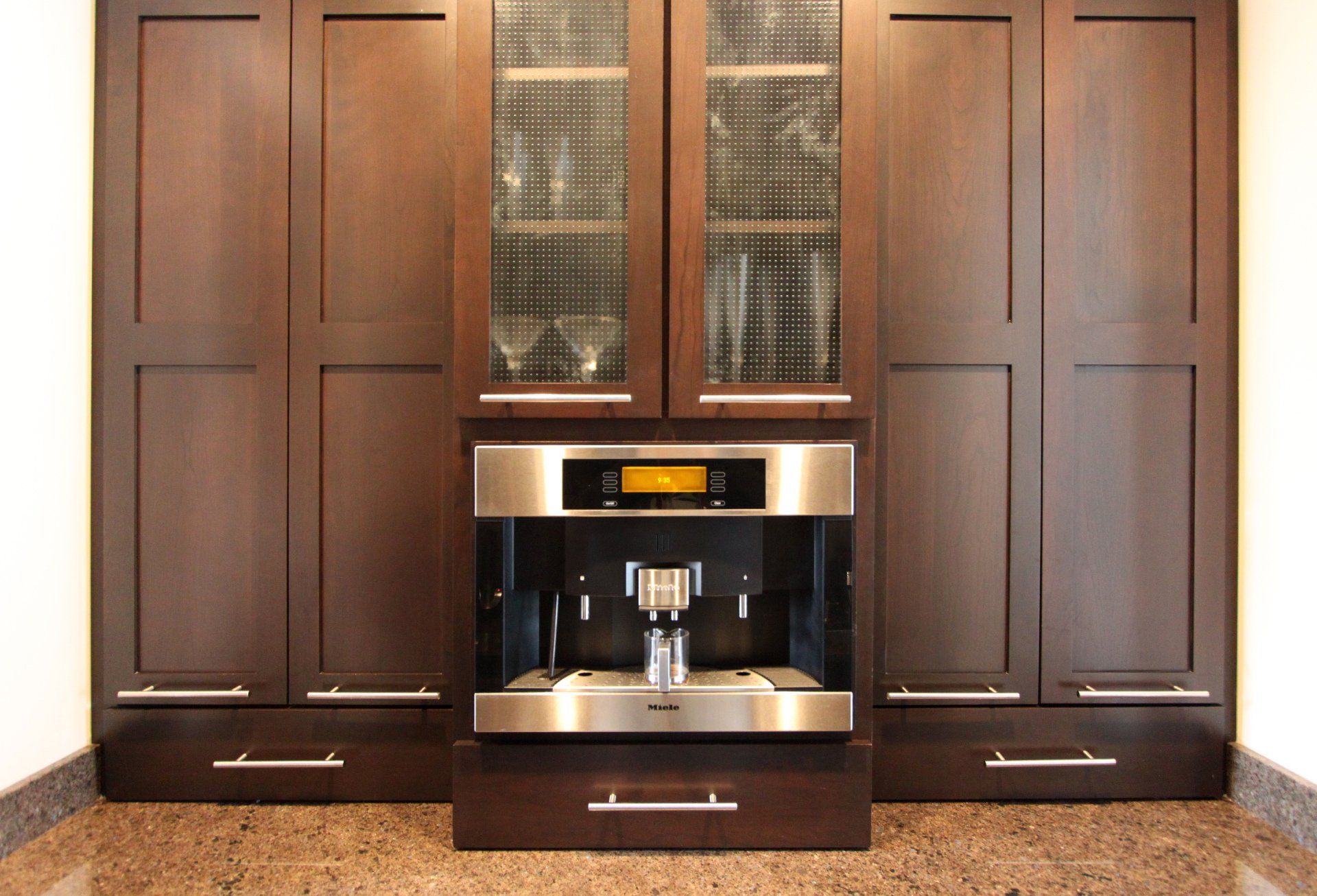A kitchen with stainless steel appliances and wooden cabinets