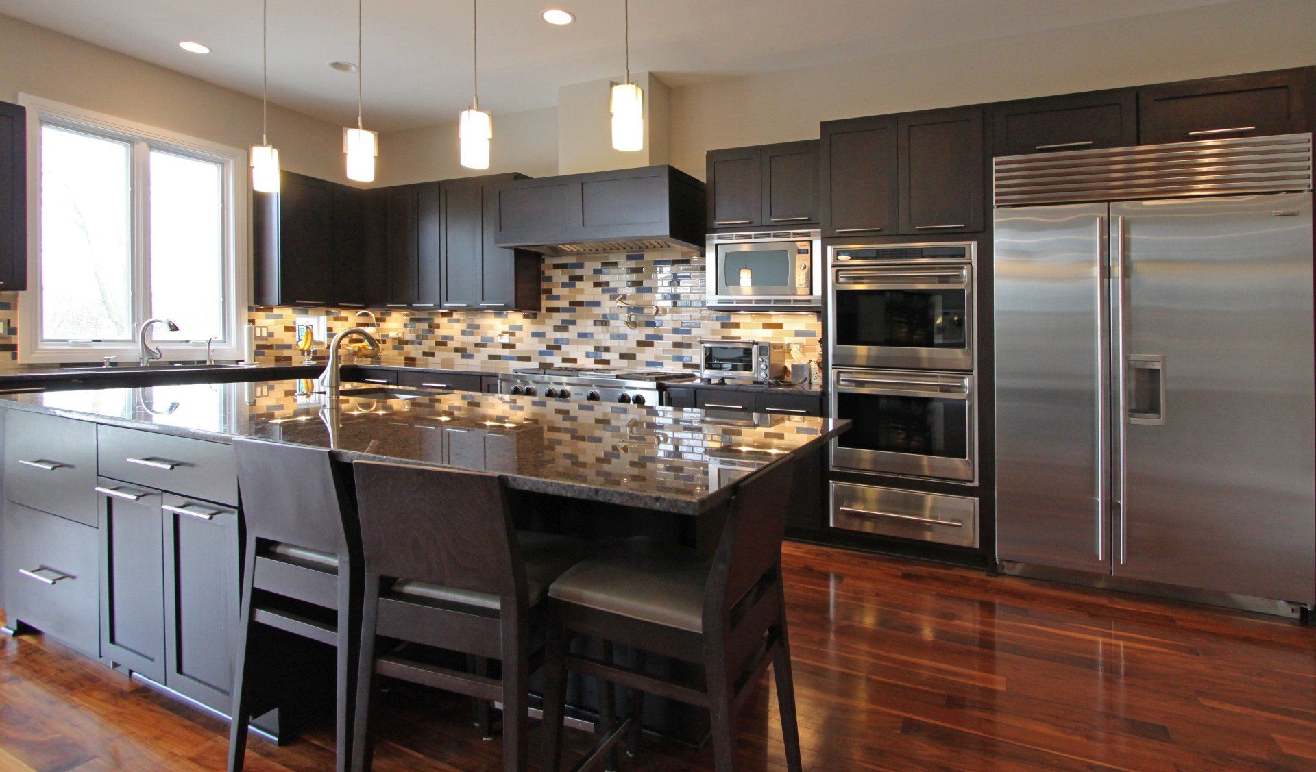 A kitchen with stainless steel appliances and a large island
