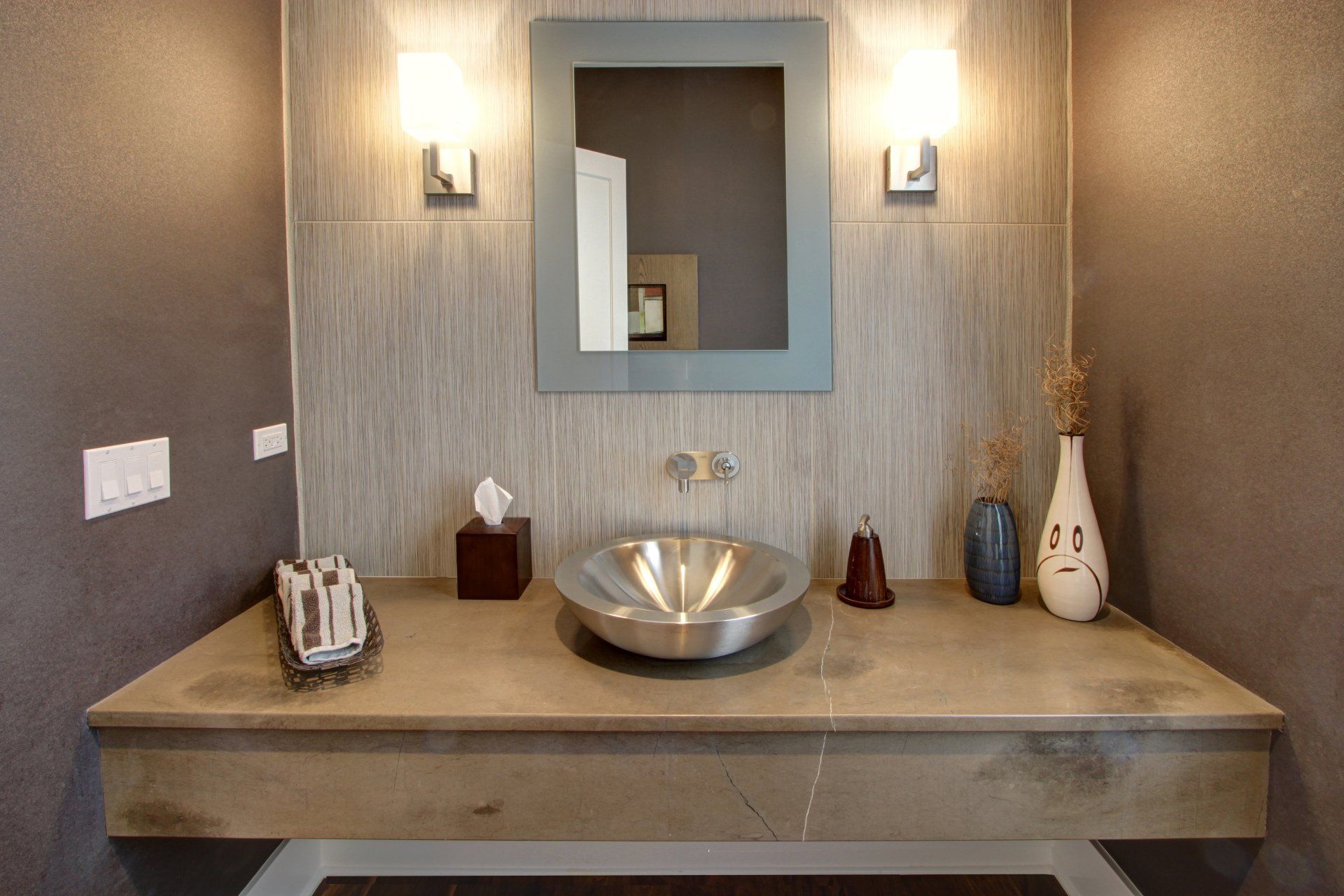 A bathroom with a sink and a mirror on the wall