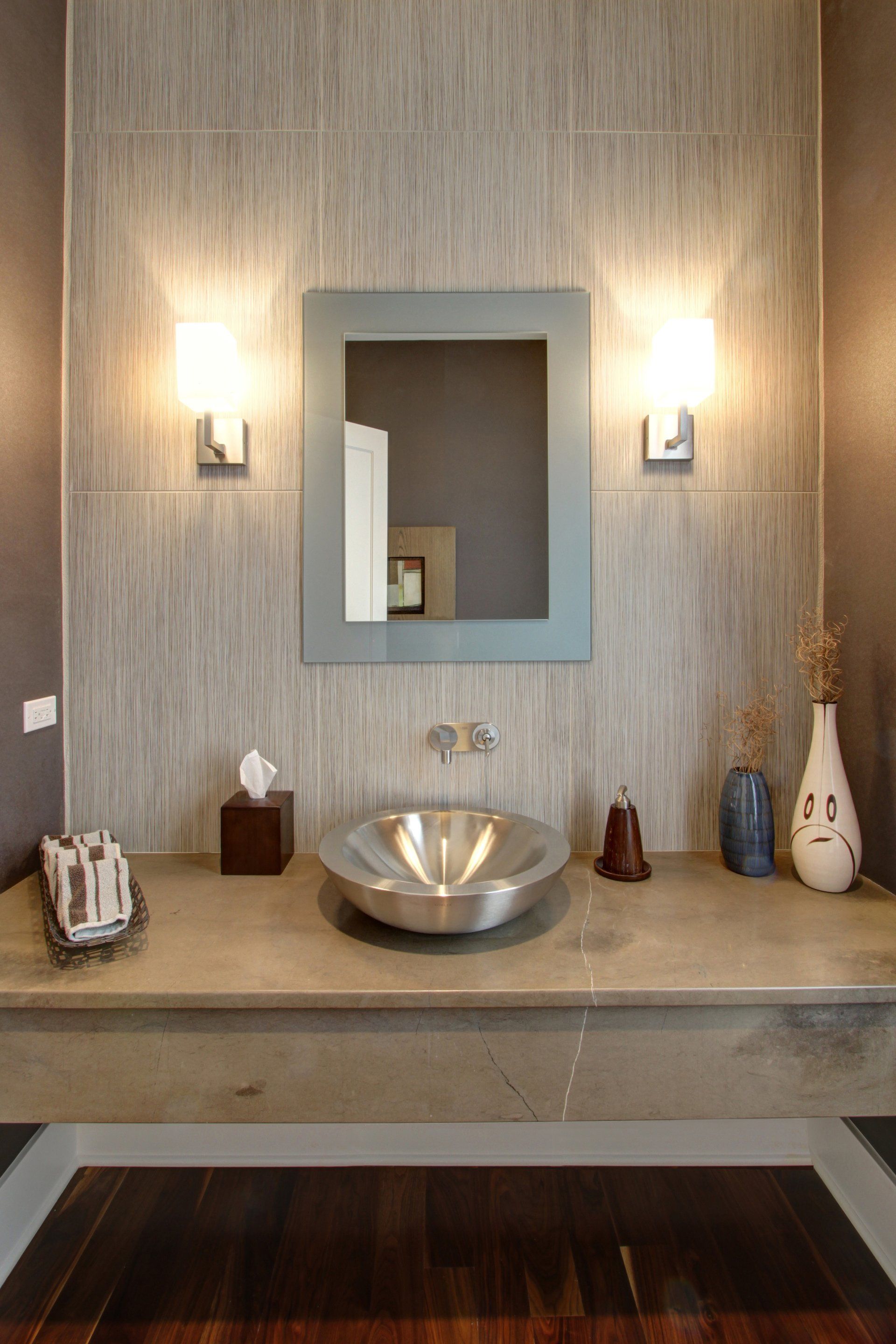 A bathroom with a sink and a mirror on the wall.