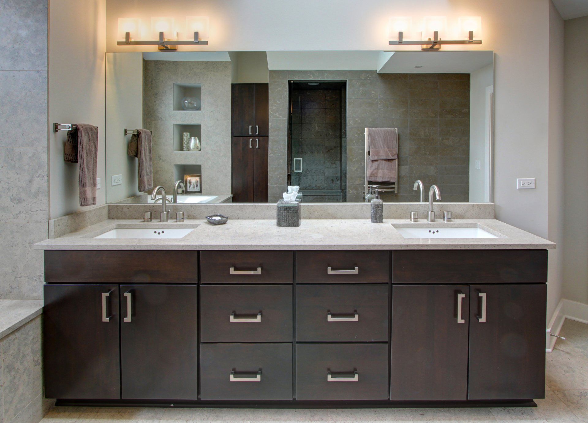 A bathroom with two sinks and a large mirror.
