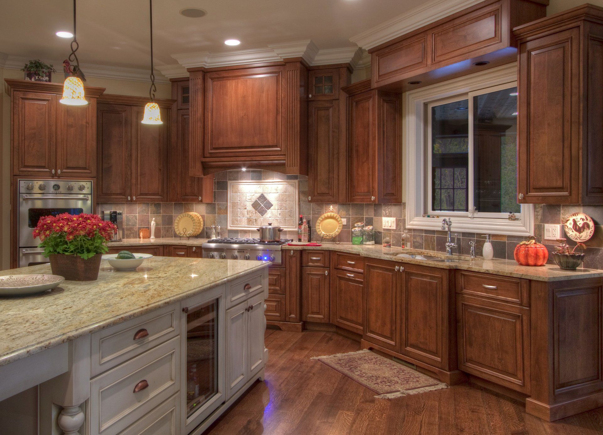A kitchen with wooden cabinets and granite counter tops.