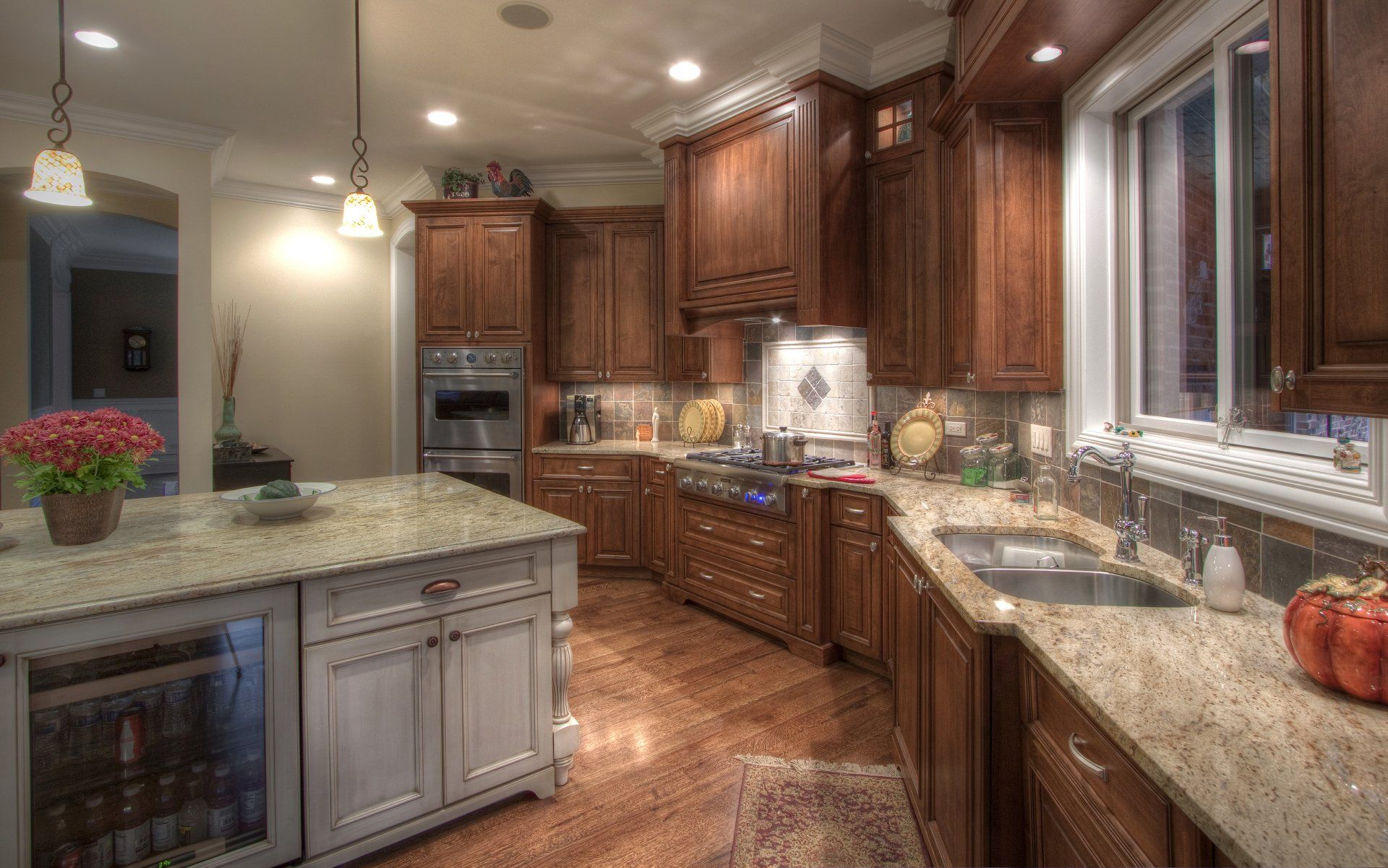 A kitchen with wooden cabinets and granite counter tops.