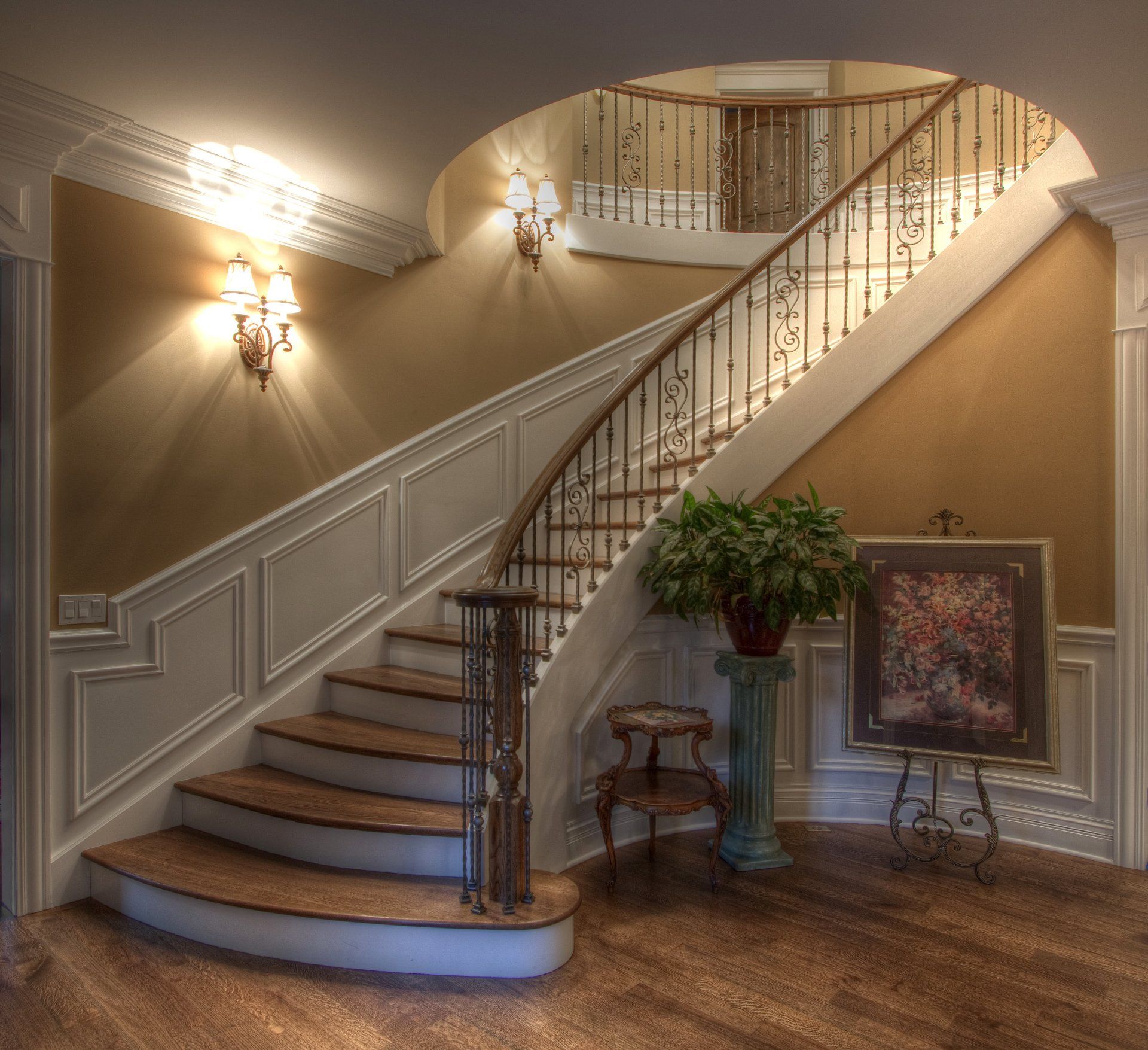 A staircase in a house with a painting on an easel