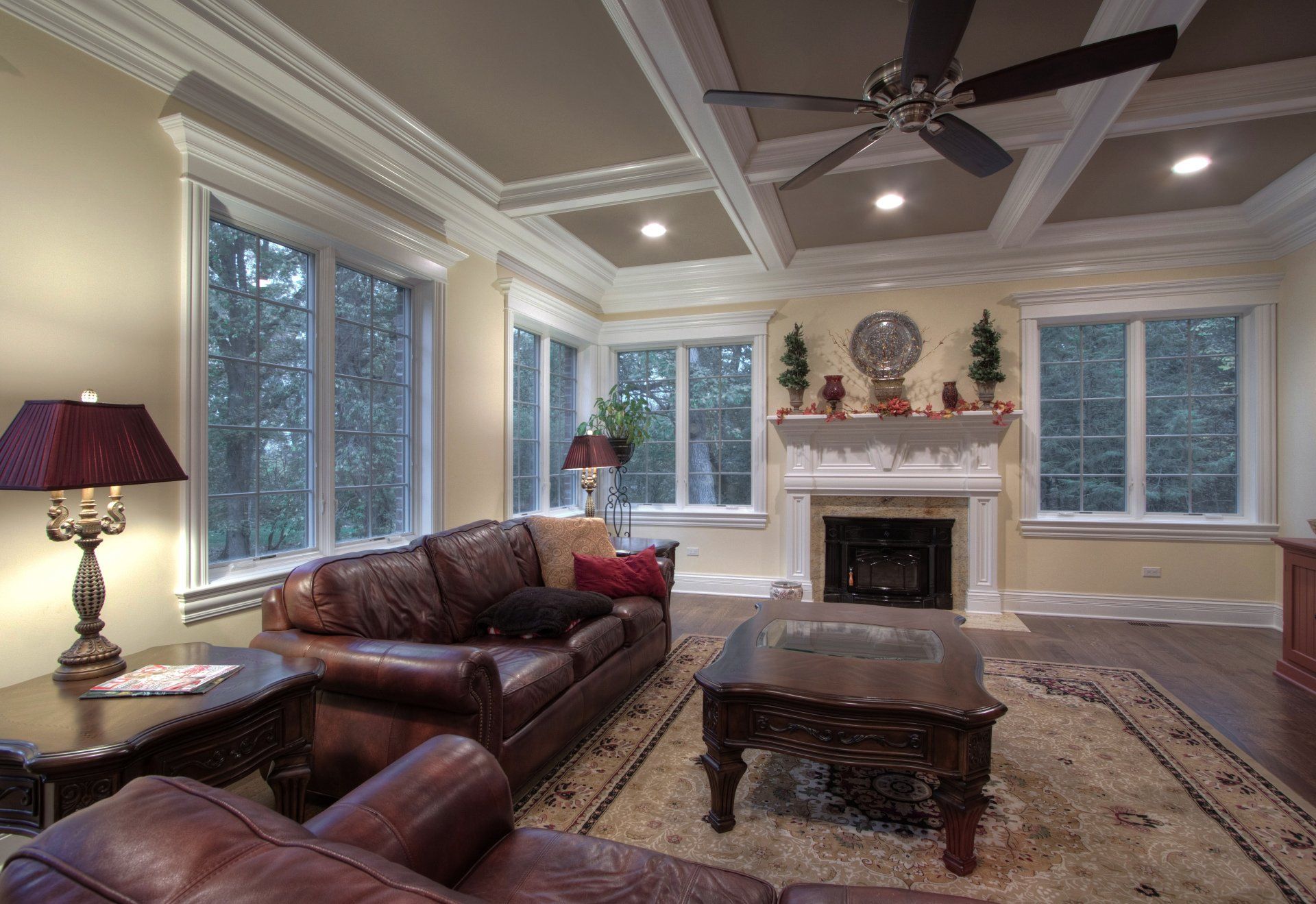 A living room with a fireplace and a ceiling fan