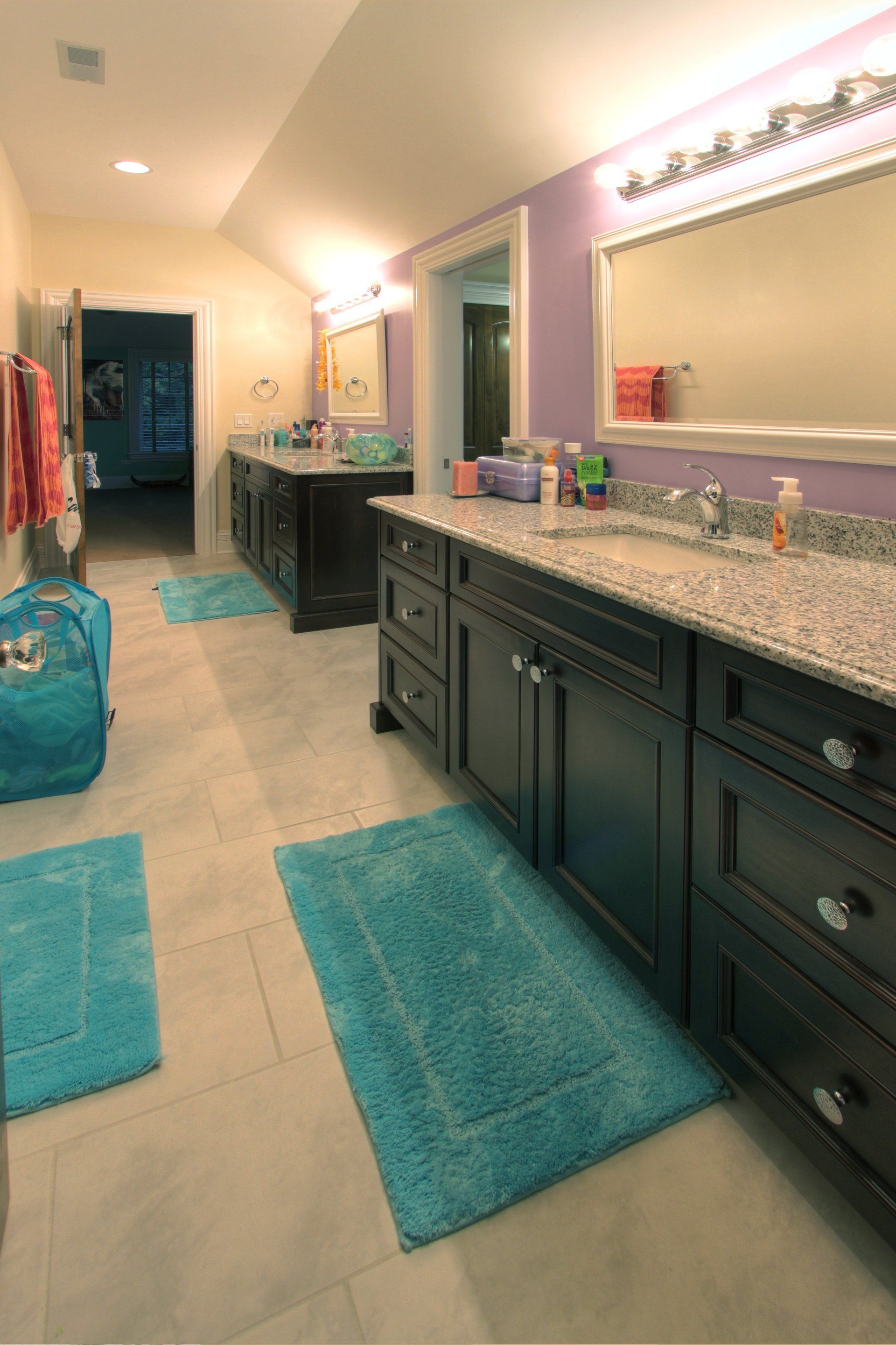 A bathroom with two sinks and a large mirror