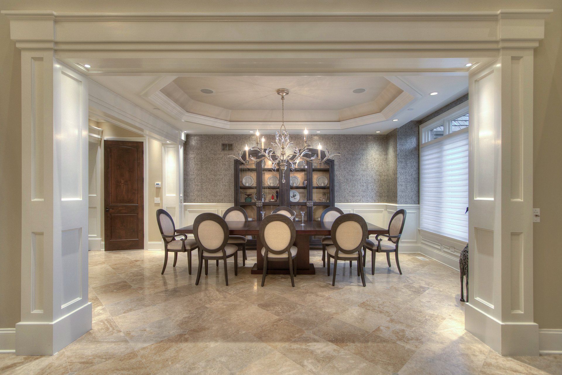 A large dining room with a table and chairs and a chandelier