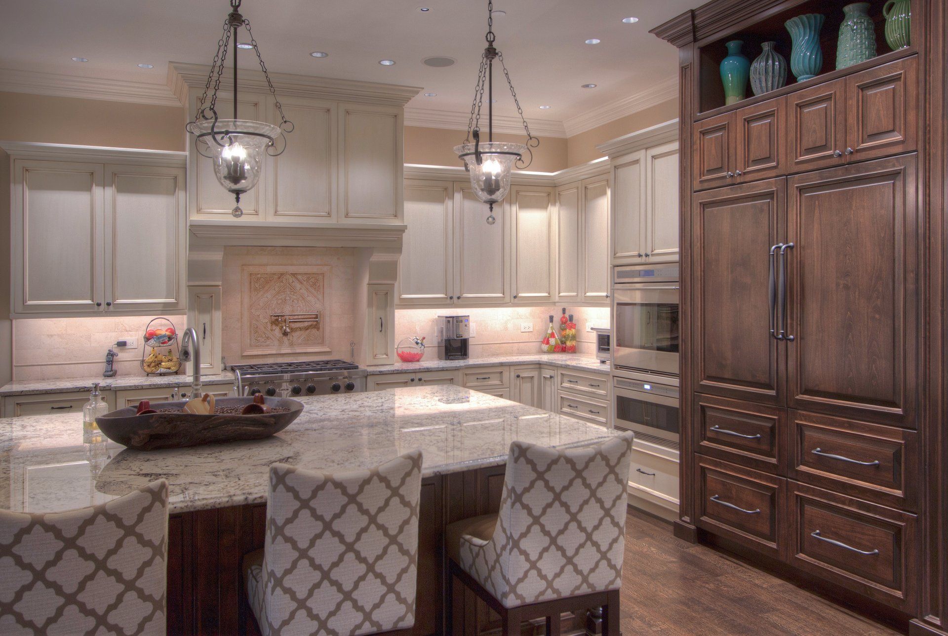 A kitchen with white cabinets and a large island.