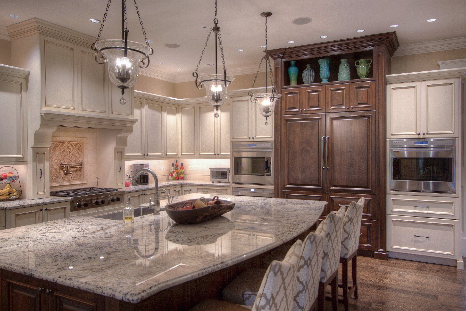 A kitchen with granite counter tops and stainless steel appliances