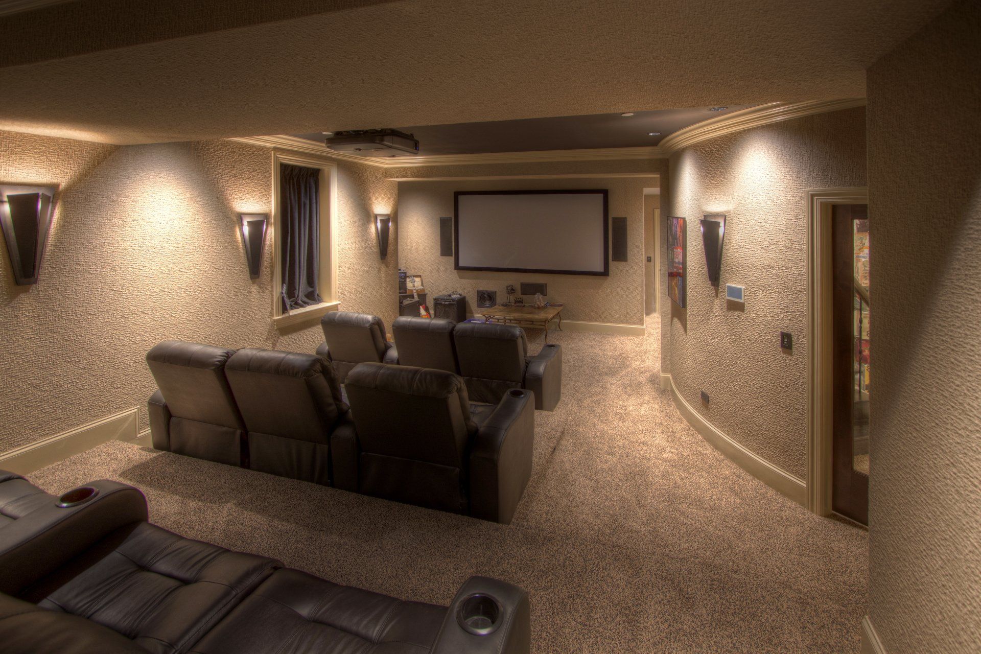 A home theater with a projector screen and a couch