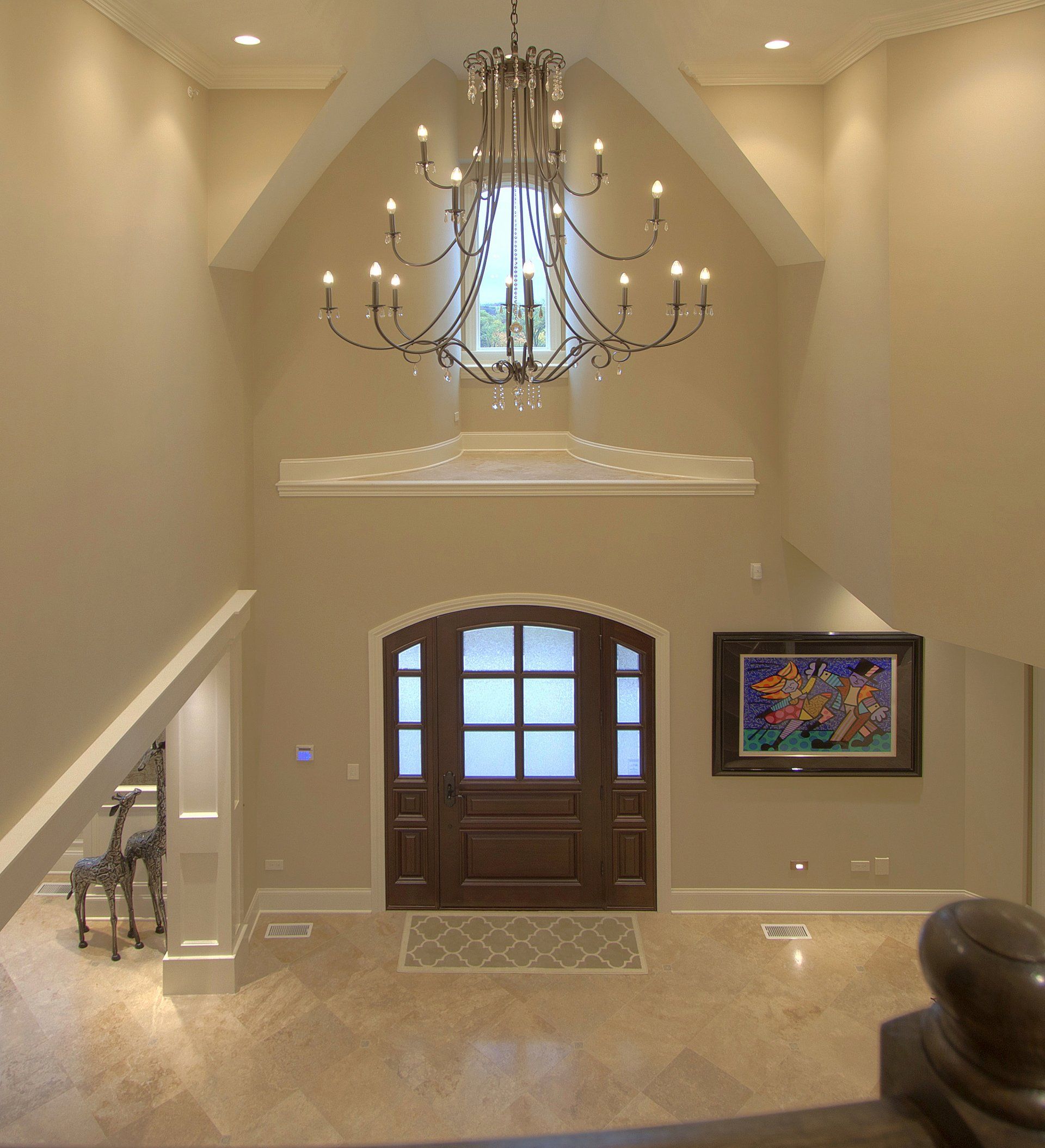 A large hallway with a chandelier hanging from the ceiling