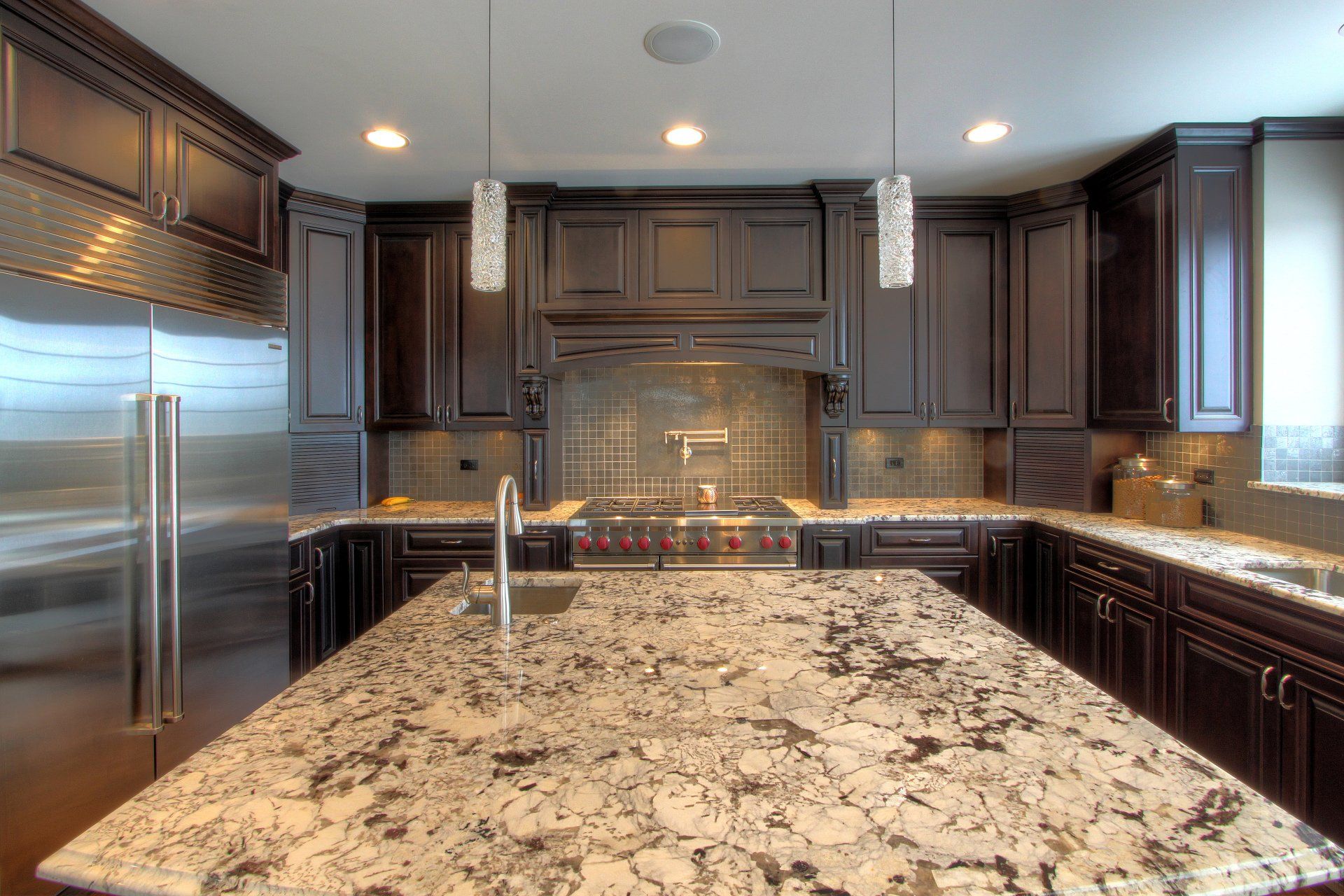 A kitchen with granite counter tops and stainless steel appliances.